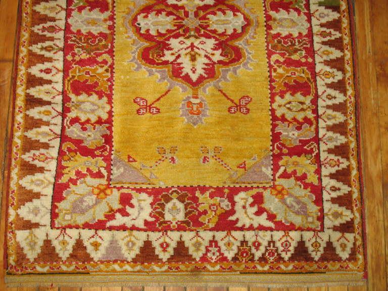 An authentic Turkish Melas rug featuring a bright yellow field.

3'3'' x 4'8''
