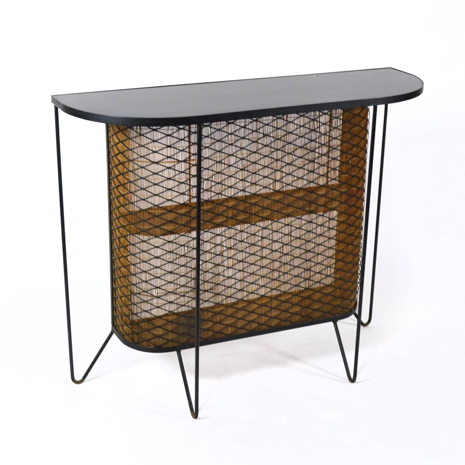 A delightful design which perfectly displays the play aesthetic of American Mid-Century Modern as designers experimented with simple materials like iron rod, expanded metal, and matchstick bamboo. Here, Weinberg used them to great effect, creating a