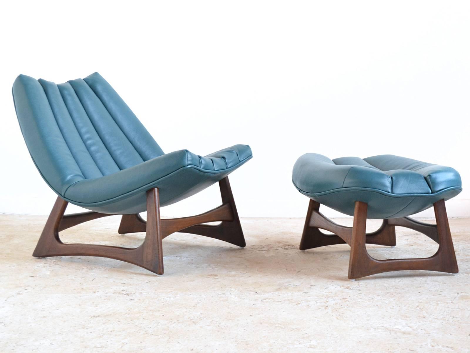 Many of the best Adrian Pearsall designs combine fluid lines and sculptural wood bases. This uncommon lounge chair and ottoman have both of those qualities. The walnut bases support the chair and ottoman which both have curved bottoms creating a