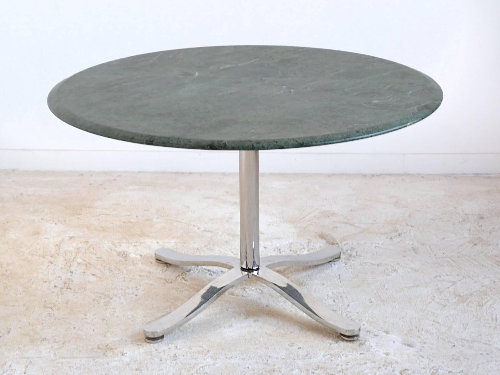 Zographos' aesthetic is one of quiet refinement, elegant lines, subtle details, and impeccable craftsmanship. This pedestal table designed in 1961 has a base of polished stainless steel and a emerald green marble top. Some of the delightful details