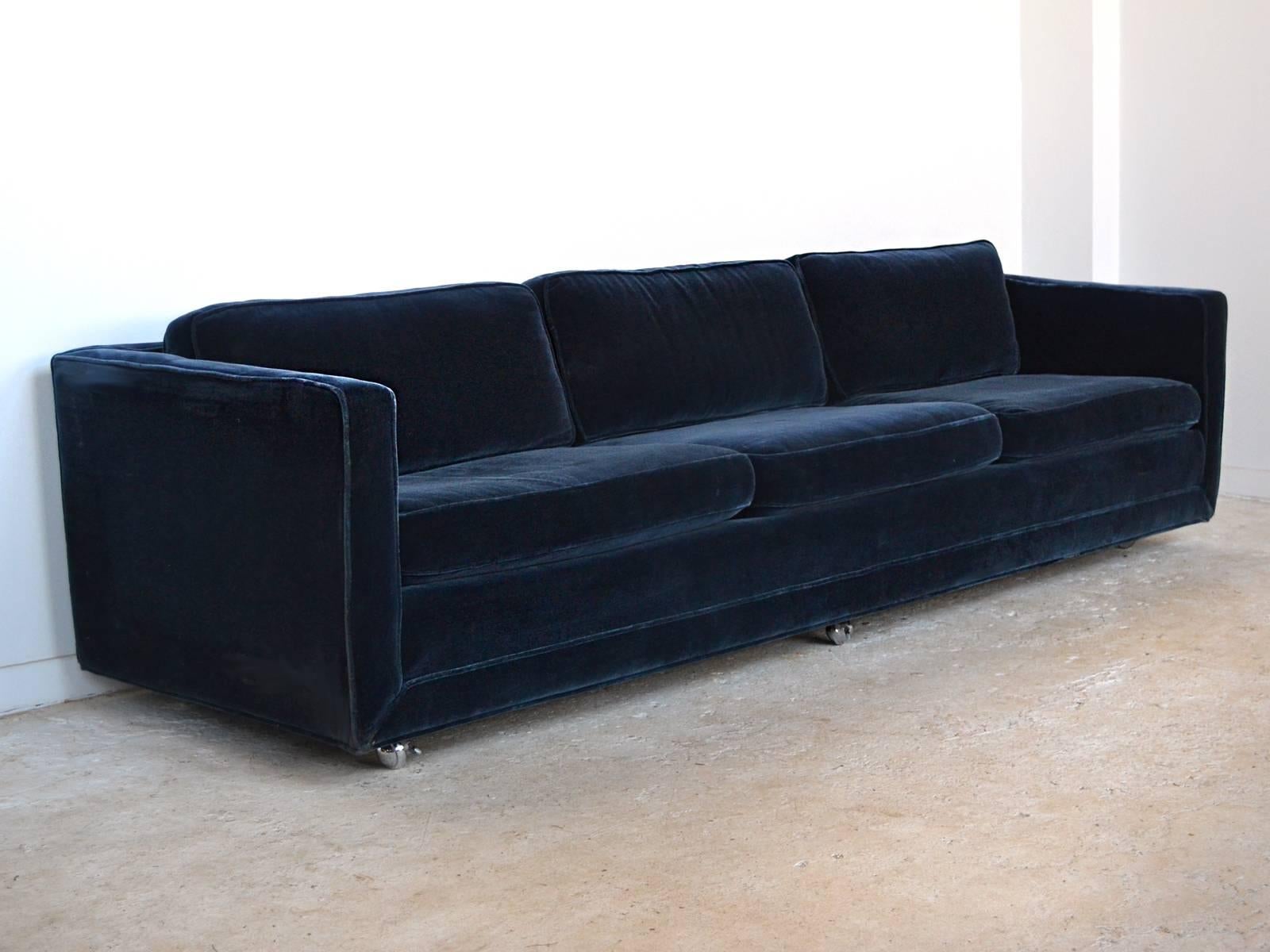 This long, luxurious 9 foot sofa by Ward Bennett is upholstered in rich French ultramarine blue velvet mohair. Perfectly proportioned, it has a sumptuous seat with down-filled back cushions and is supported by chrome caster feet.