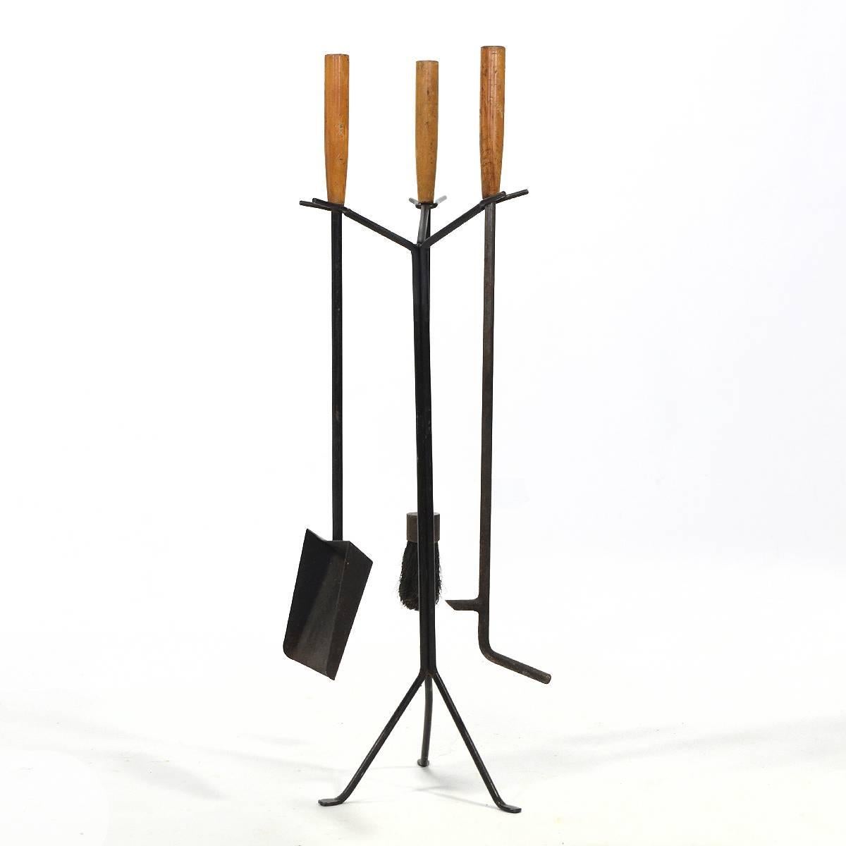 This set of model H609 fireplace accessories designed by George Nelson for Howard Miller have a clean, spare design and are supported by a tripod stand. They have acquired a rich patina from years of use.