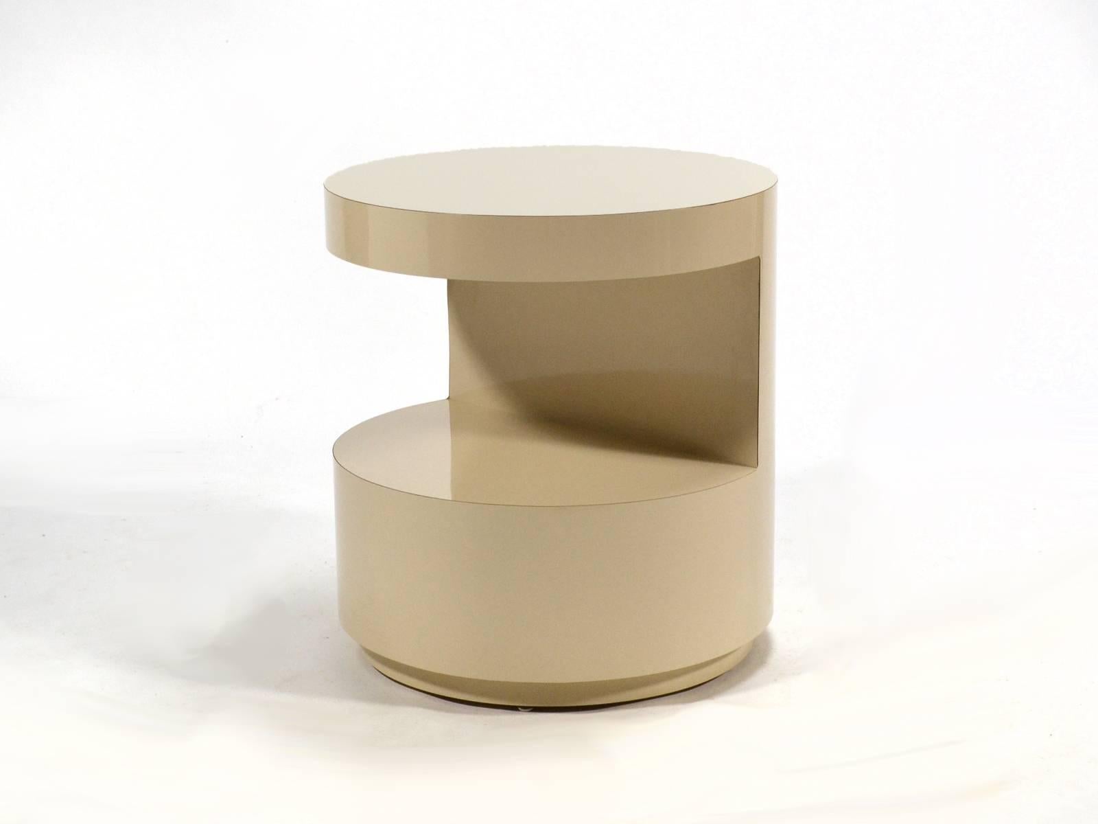 This side table by noted Chicago interior designer David Russ is a cylindrical form with a cut-away on one side creating a shelf below the cantilevered top. The inset plinth base gives the substantial shape a lighter footprint.
