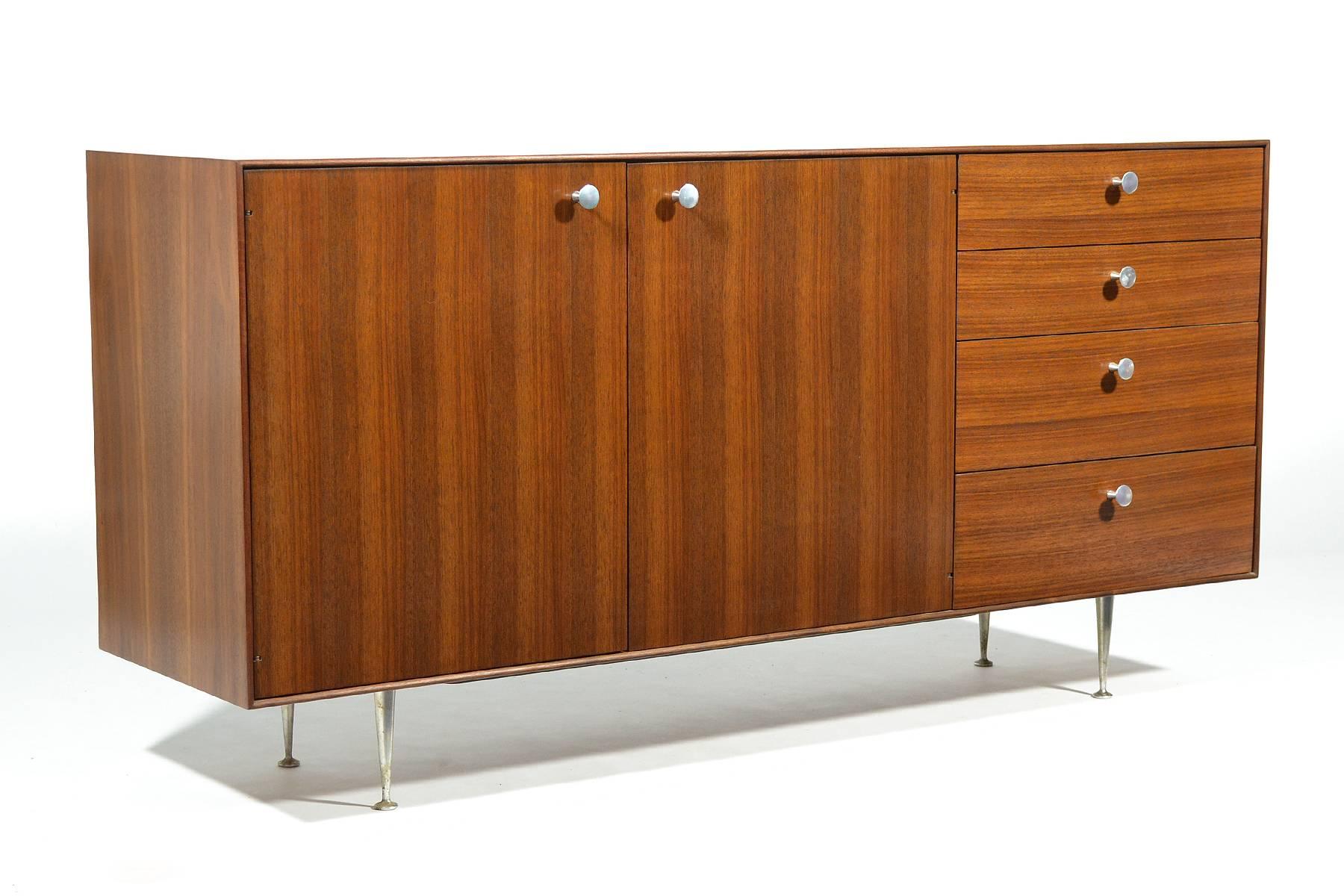 We have had many Nelson case goods over the years, and this one is unquestionably our favorite. While the thin-edge group is usually seen in rosewood, this example is clad in beautiful walnut and features matching brushed aluminum pulls and legs.