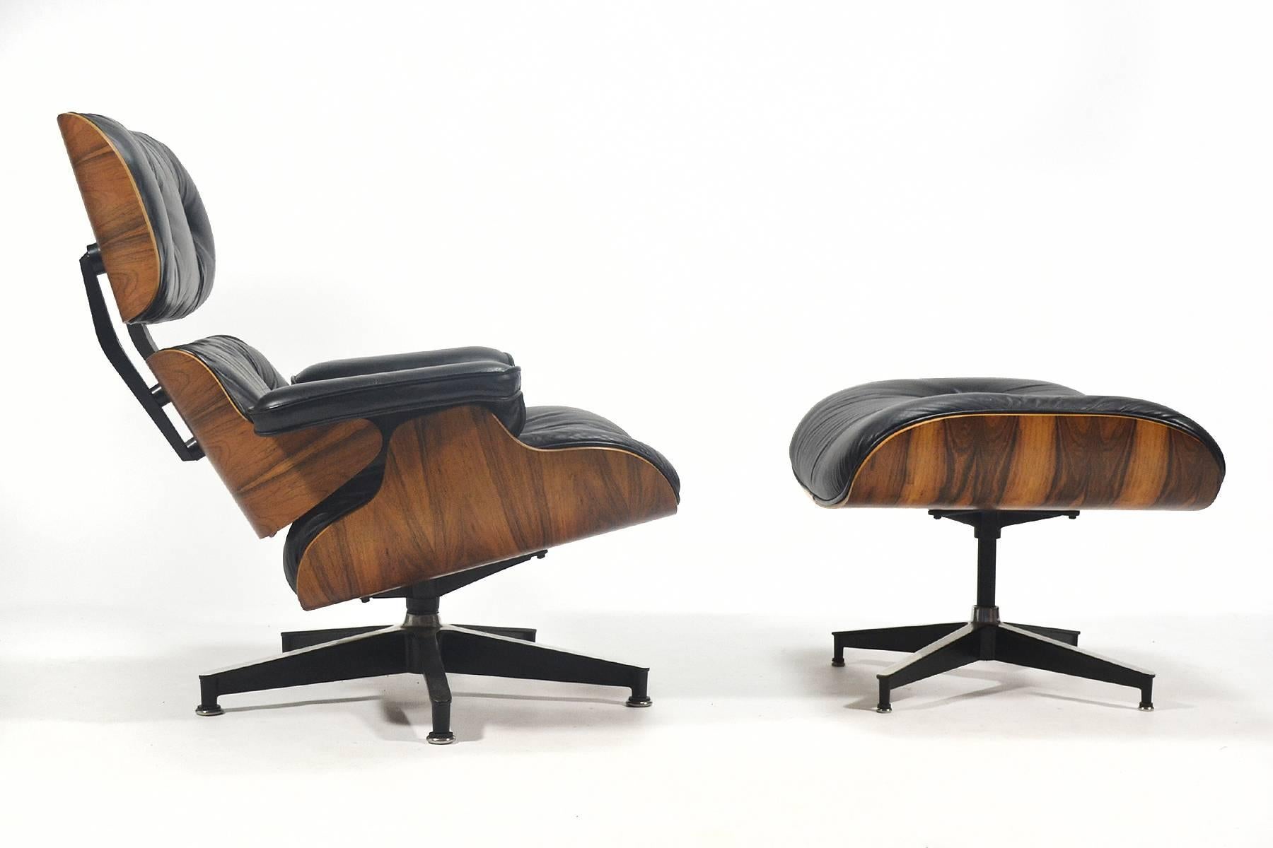 This Eames lounge chair and ottoman is a terrific vintage example dating from the late 1970s. It has black leather cushions and the rosewood shells are very beautiful. Nicely figured with great color and contrast, this set makes clear the reason