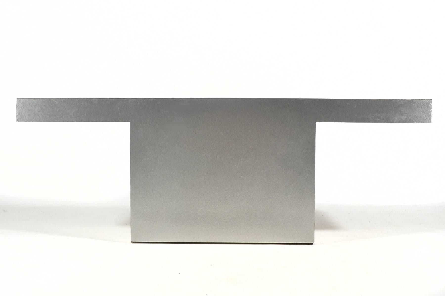 A strong, Minimalist form clad in silver textured mica this table is perfect in an entry or behind a sofa where it can make a powerful statement and be the perfect surface for the display of beautiful objects.