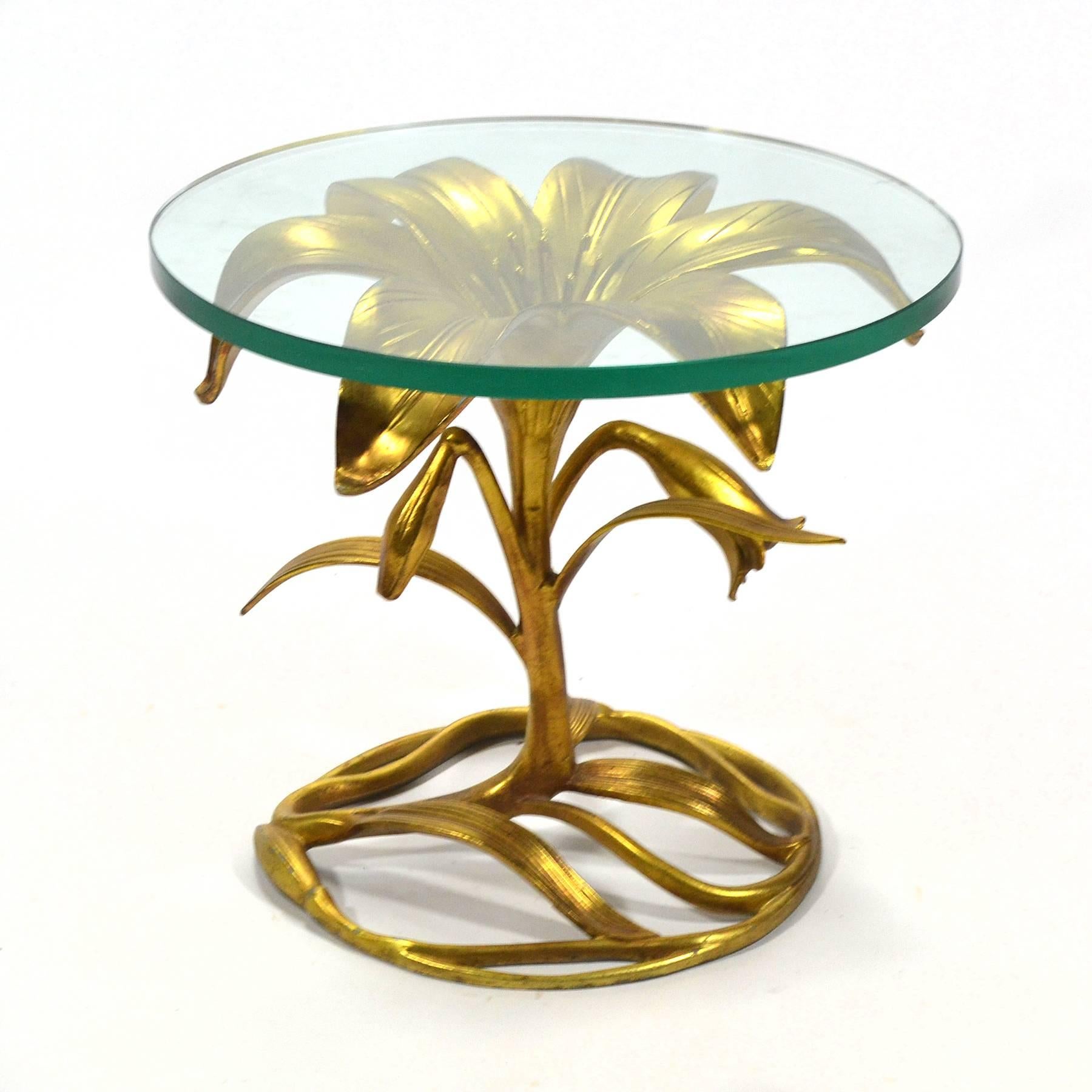 This striking gold gilded aluminum lily-form table by Arthur Court strikes just the right luxurious note. Topped with thick glass and the Art Nouveau inspired base is beautiful from every angle.