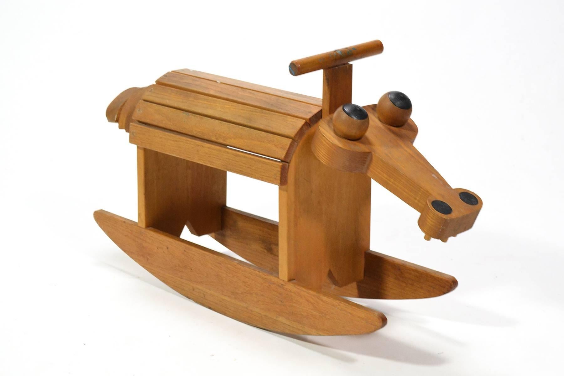 A terrific piece for kids to play with and a visual delight for adults, this handcrafted hobby horse in the form of a fanciful creature (perhaps an alligator) is well built in addition to being a wonderful design.