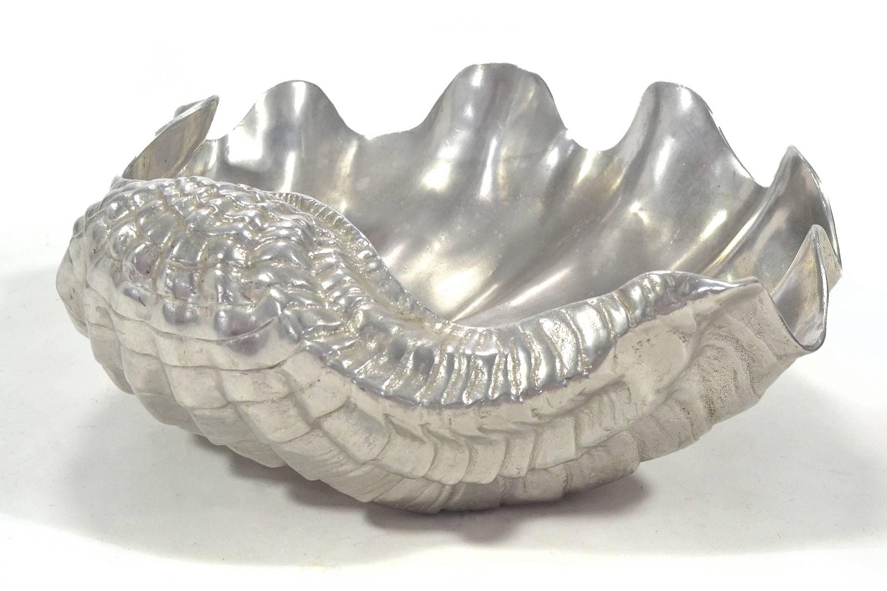 A striking piece by Arthur Court in the form of an extra large clam shell, this piece has great presence. It can serve many purposes from a centerpiece, to a serving bowl, a punch bowl, a soup tureen to our favorite and a champagne bucket. This