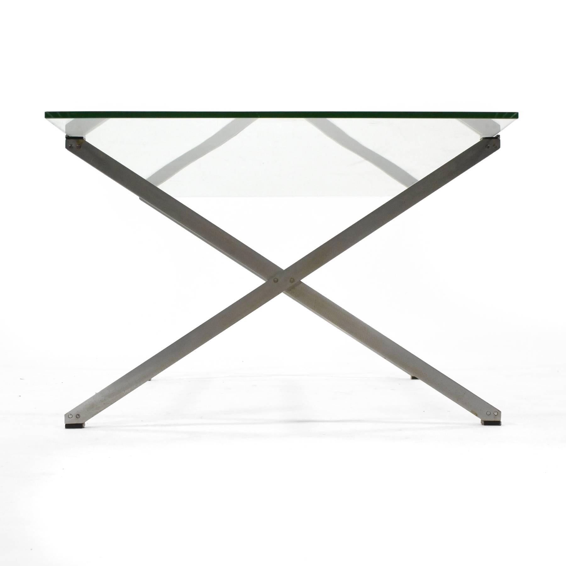 This model 405 coffee table design by Florence Knoll was designed in 1955 as part of the parallel bar group which included lounge chair and sofas designed with the same double steel bars for legs/ base. The spare design is elegant in its Minimalist