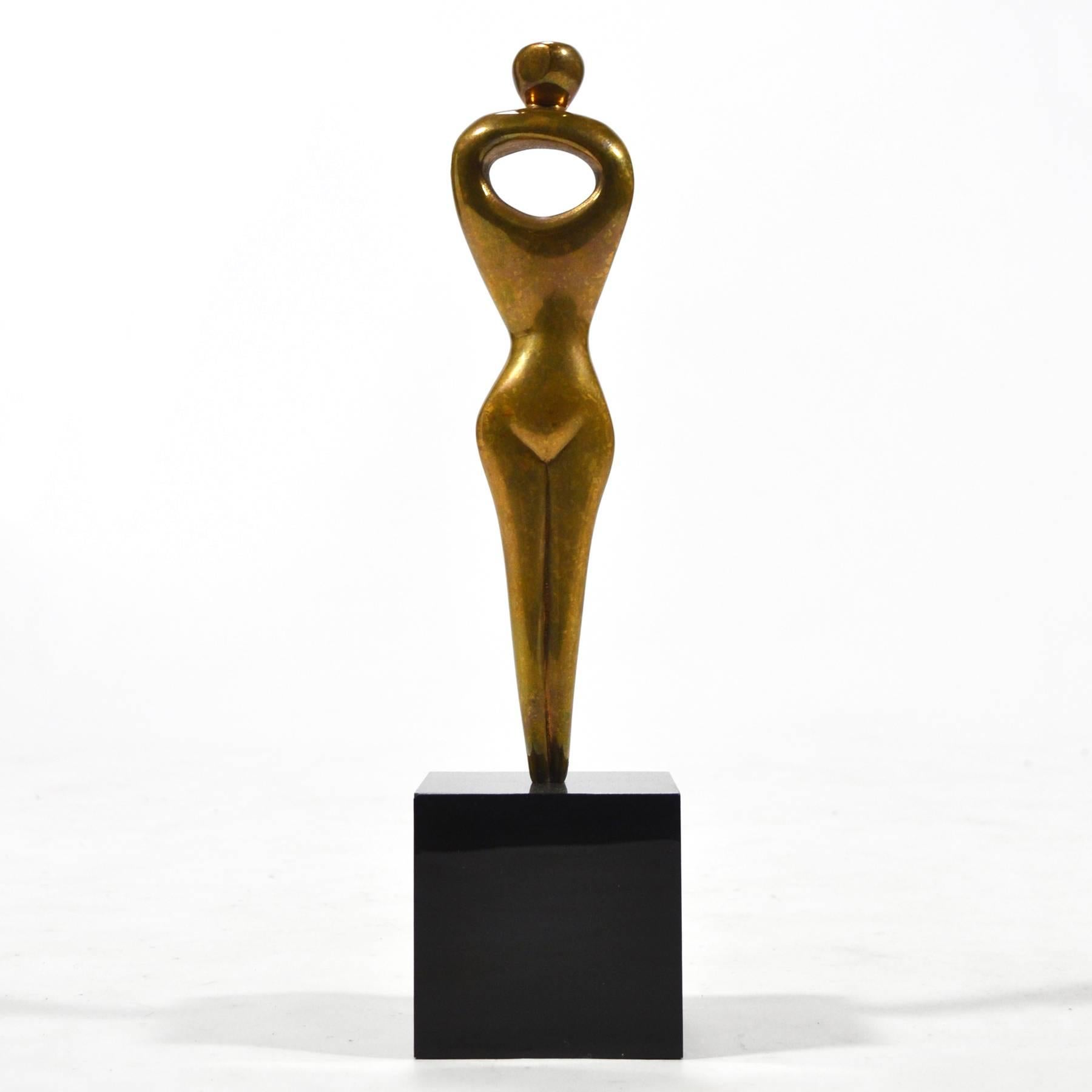 A sublime abstraction of a female figure, this bronze sculpture by Alfredo Burlini possesses an elegant serenity. With an economy of line, the fluid forms express the bare essentials to convey a standing figure. The pierced torso is an especially
