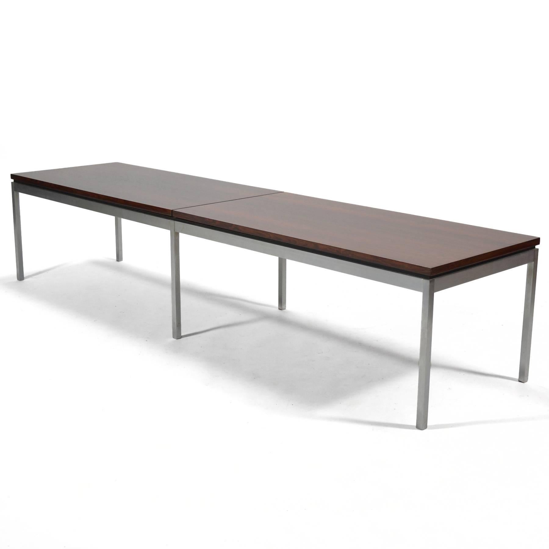 This stunning long piece by Florence Knoll can serve as either a coffee table or a bench. A base of brushed steel supports a segmented top of rich, bookmatched rosewood. Florence's refined sensibility is evident in not only in the quality