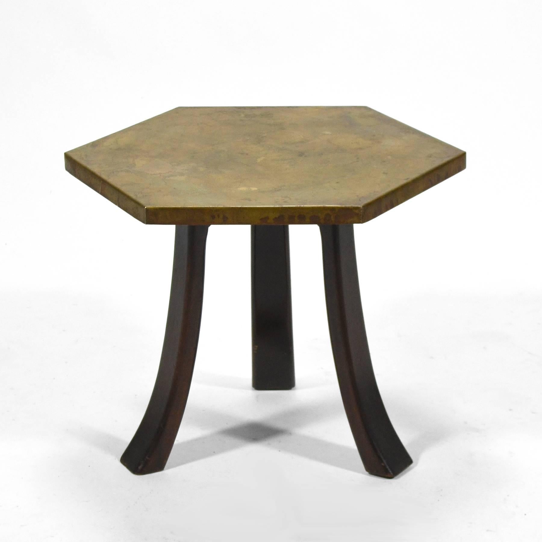 A classic design by Harvey Probber, this hexagonal side table has three splayed legs of mahogany supporting a top covered in a richly textured and patinated acid-etched bronze by Arpad Rosti.

The top measures 19