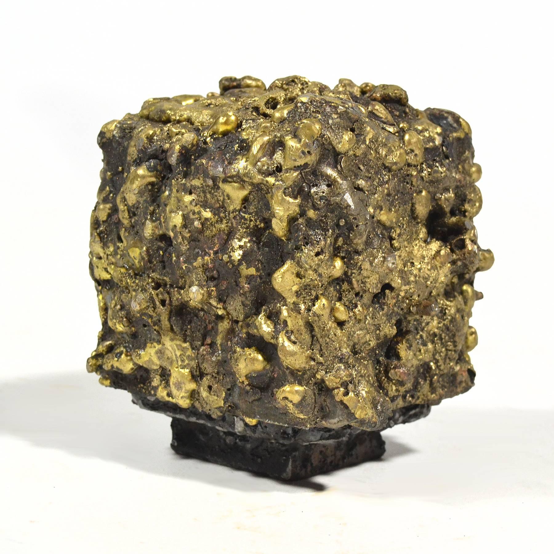 A wonderful small-scale sculpture by James Bearden, this steel cube floats on a plinth base and is covered in bronze giving it a visceral texture. Concealed inside is a small trinket box.