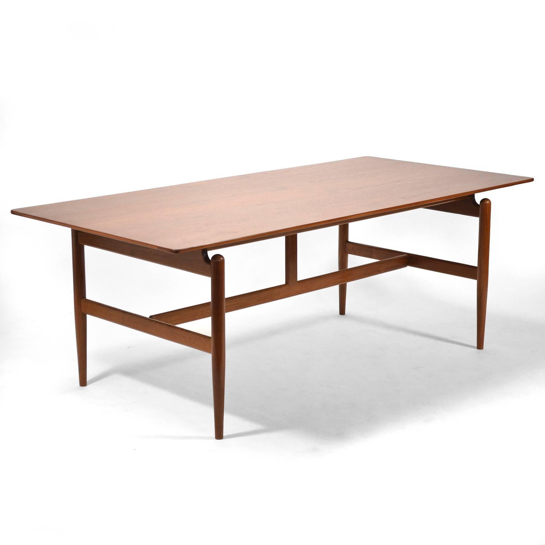 Finn Juhl designed this beautiful desk or work table for his own home before licensing it to Baker Furniture who offered it as model no. 520. Also known as the Kaufmann table, the substantial table with a floating top can also be used for dining.
  