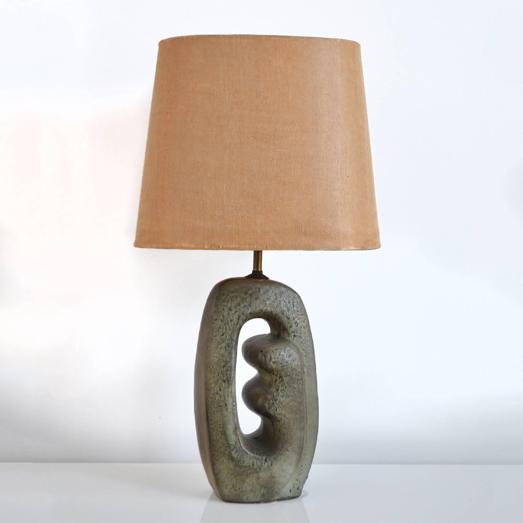 This wonderful lamp from the 1950s has a beautiful ceramic base. The abstract form features a terrific mottled glaze and the shape reminds us of the sculptures of Isamu Noguchi and Henry Moore.

Lamp is sold sans shade. The original shade shows
