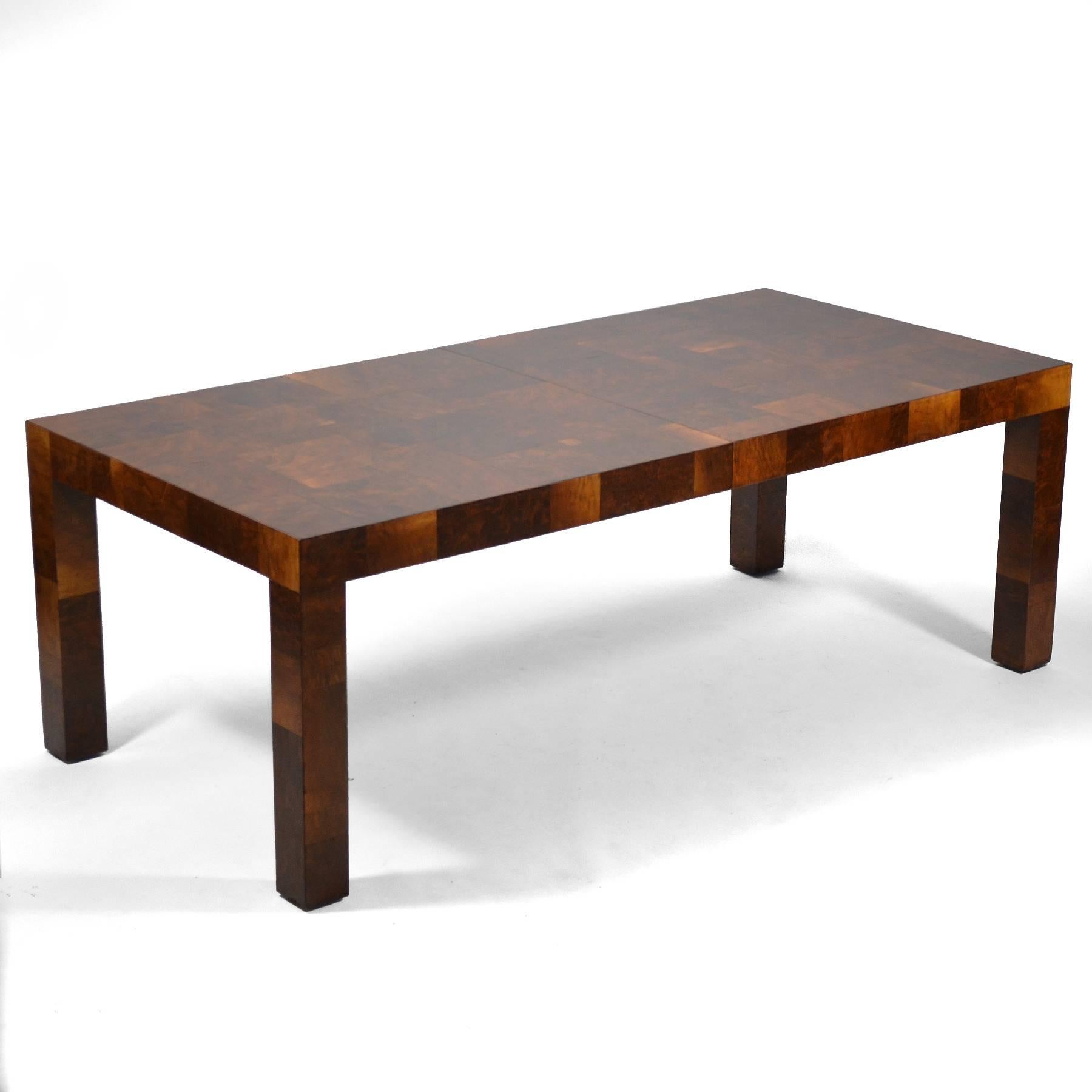 Paul Evans takes the minimalist form of a parsons table and gives it tremendous visual appeal by covering it in a patchwork of dark, rich burled walnut.