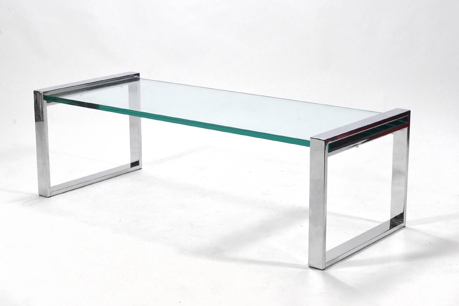 This wonderful coffee table by Cy Mann has a chromed steel base, a glass top and a great architectural quality. This seldom seen design perfectly complements Mann's chrome framed lounge chairs. This table was purchased en suite with a pair of Cy