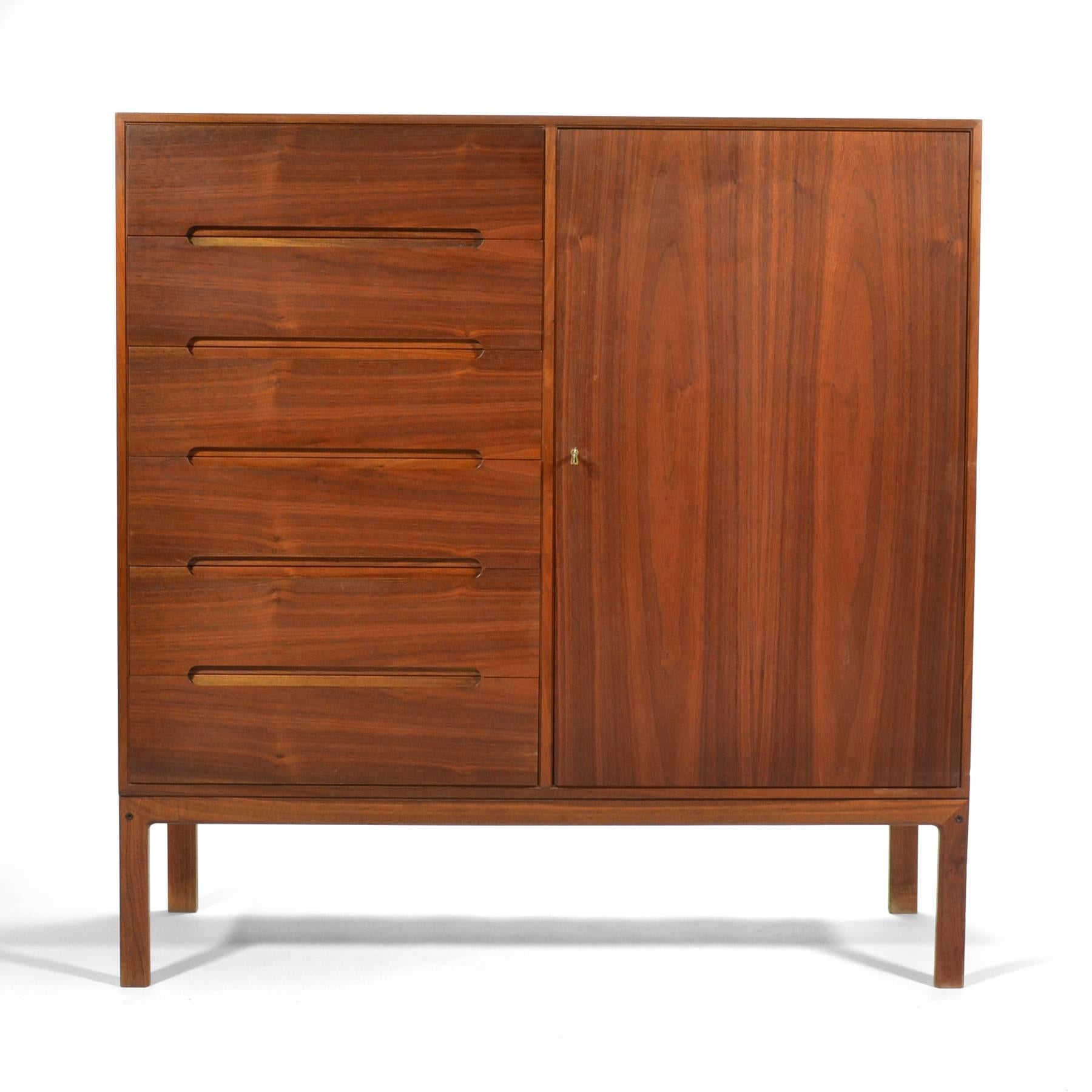 A spectacular design by Arne Wahl Iversen, this teak gentleman’s chest is as functional as it is beautiful. The left side features a bank of drawers with beautiful recessed pulls while the right side has a locking door that conceals a bank of