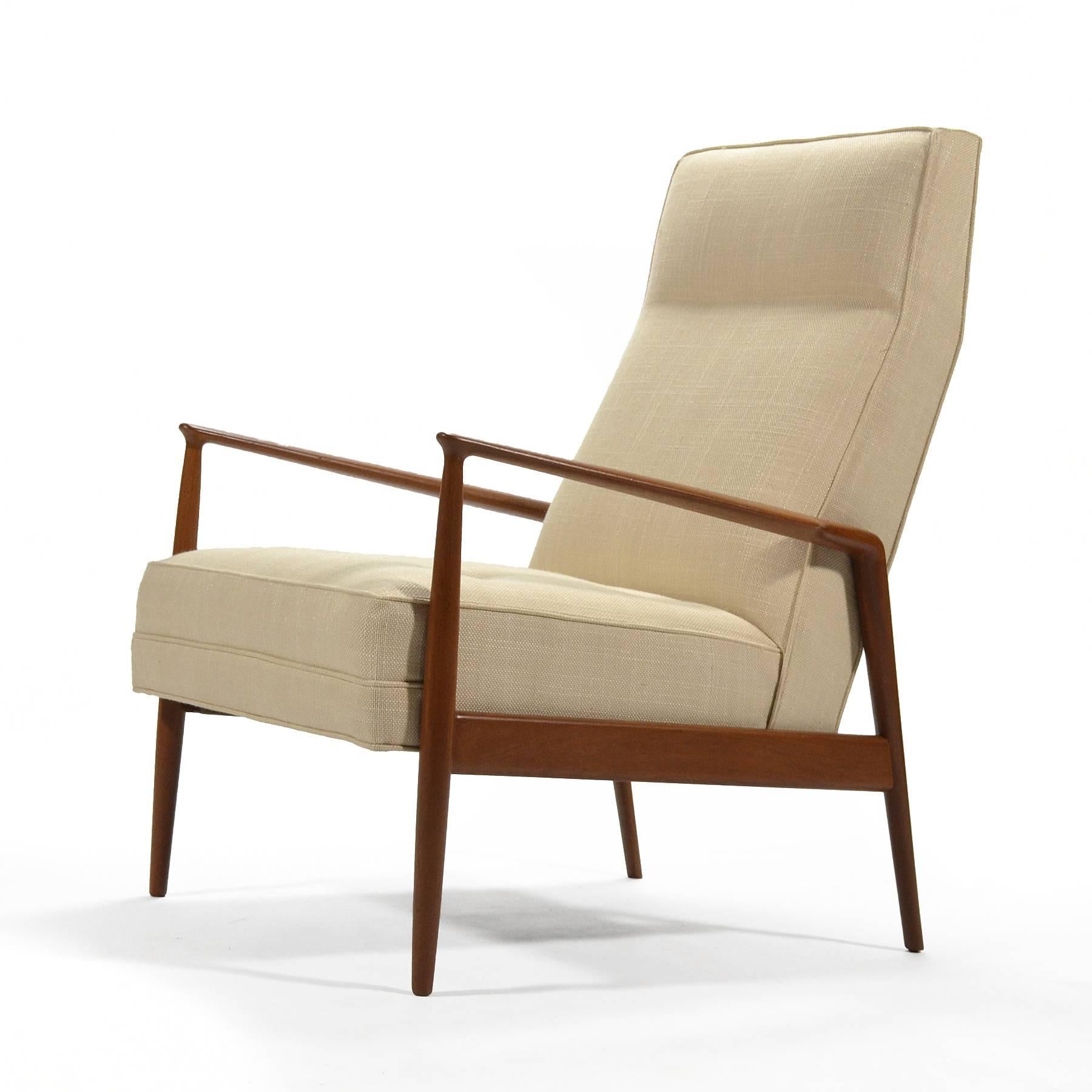 This beautiful, stately design by Kofod-Larsen is Classic Danish modern. The teak frame has wonderful sculptural details and supports an upholstered seat. Newly restored and reupholstered, this is a very stylish and comfortable lounge chair.