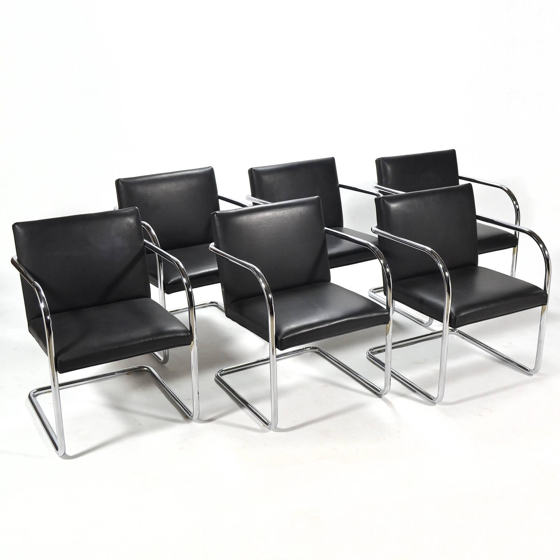 This nice set of six Mies Brno chairs are well made examples of the Classic design. True to Mies' Minimalist ideal, they have a spare cantilevered steel frame which supports the clean-lined upholstered seat and back. Like an armchair version of a