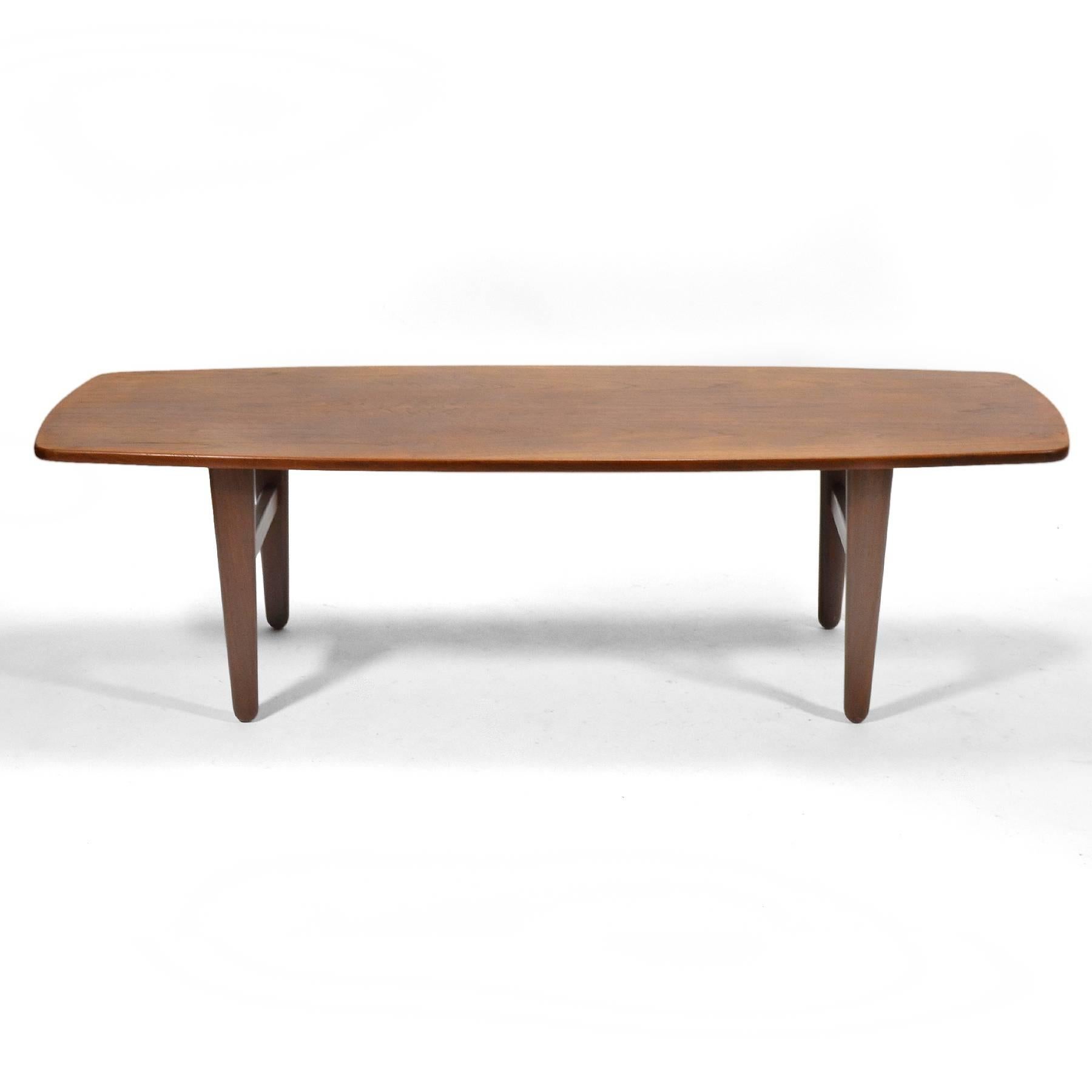 Wonderful teak Svend Madsen coffee table by K. Knudsen & Son with softly curved lines and tapered legs.