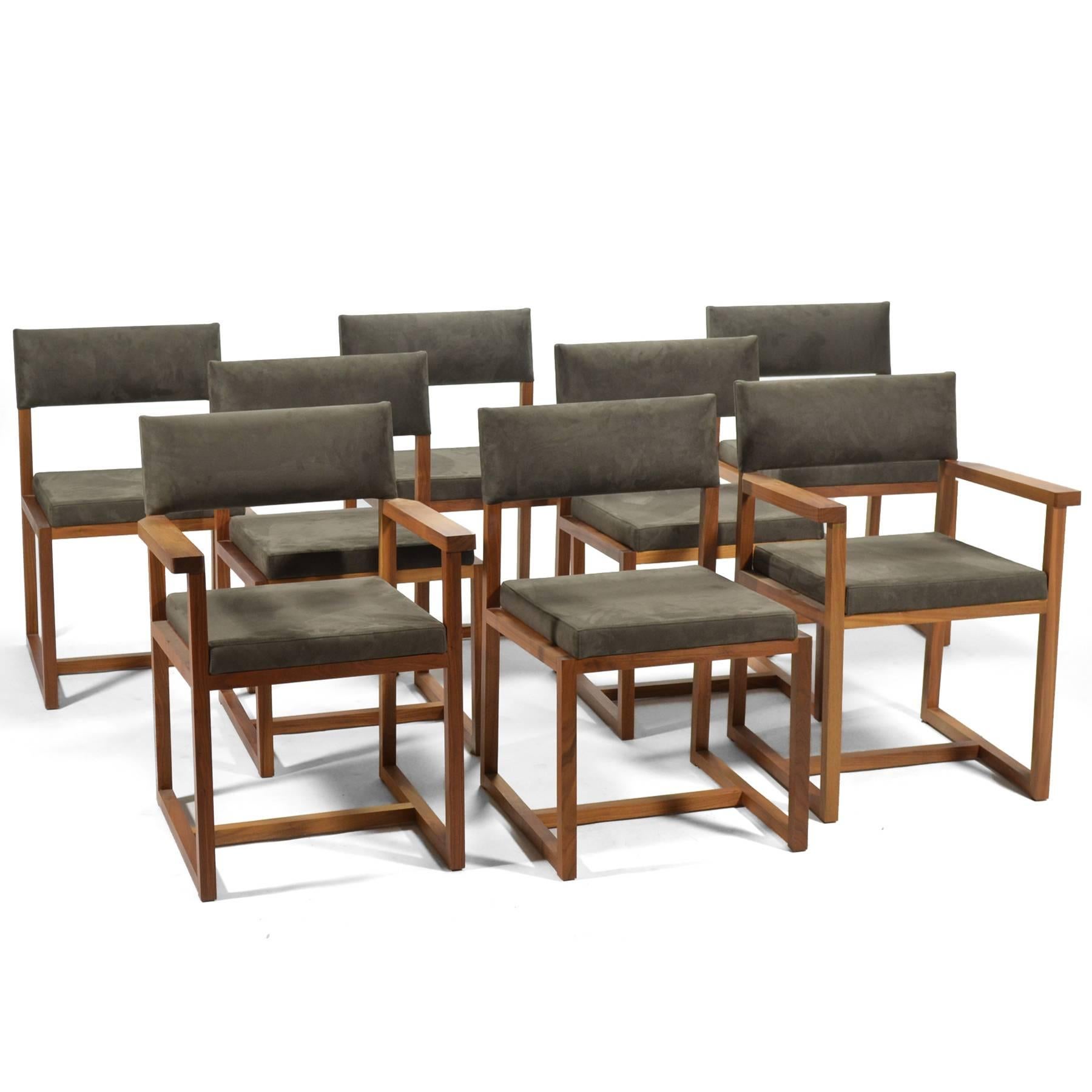 This set of eight dining chairs by De La Espada are made of rich, solid black American walnut and are upholstered in a nice gray ultrasuede. The model 133 