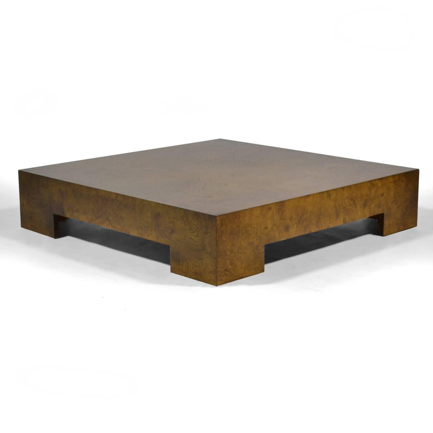 This wonderful coffee table designed by Milo Baughman uses an elegant minimalist form activated with a veneer of dark, rich, olive ash burl wood.