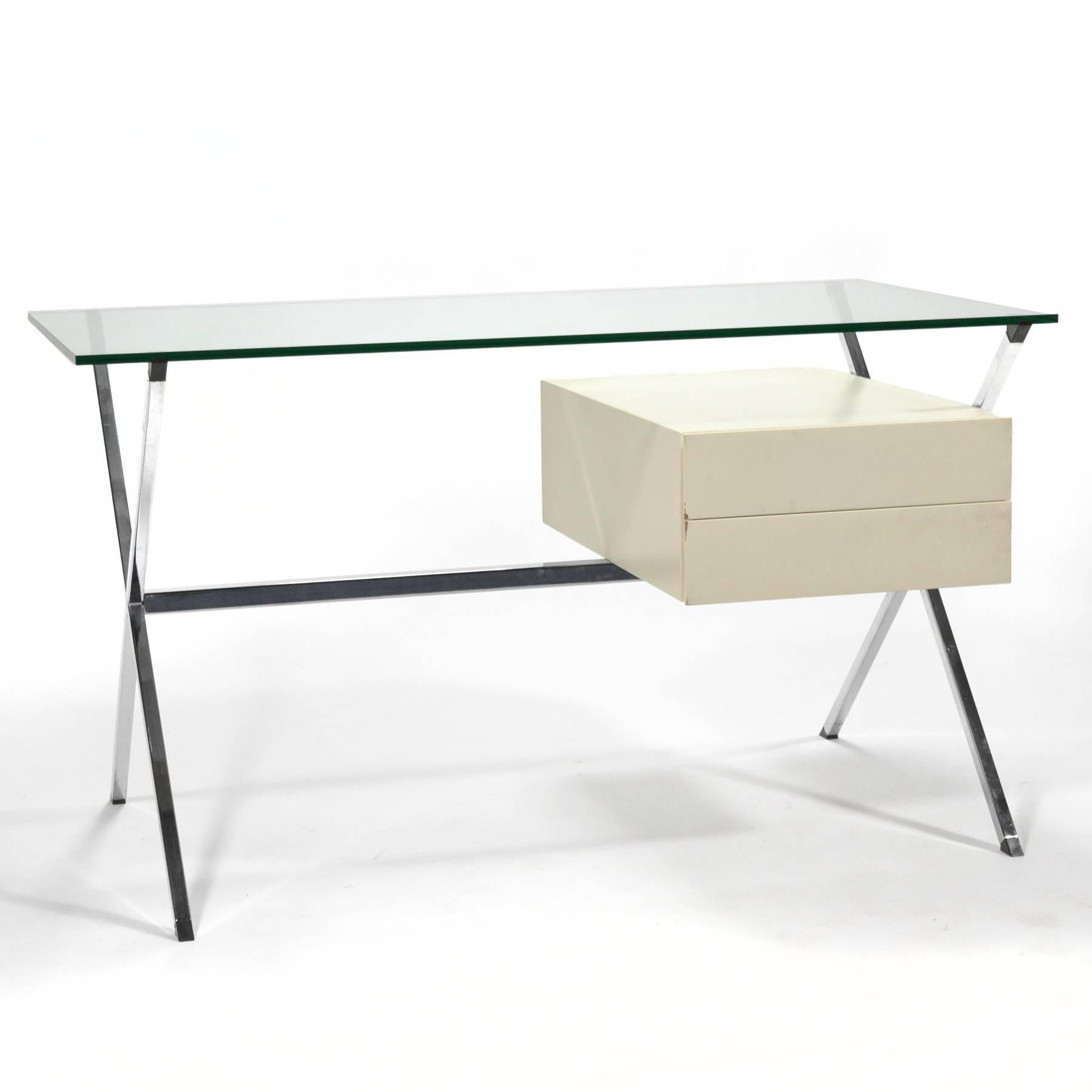 This beautiful minimalist desk was designed by Franco Albini in 1928. This example is a later edition by Knoll. It features a chromed X-form base supporting a glass top and an ivory lacquered oak two-drawer case.