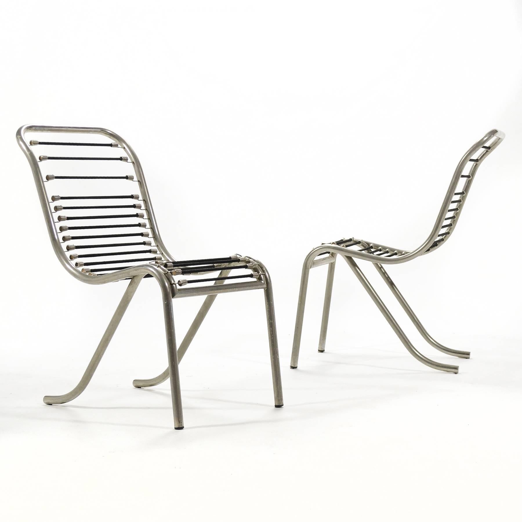 This exceptional and rare pair of René Herbst Sandows chairs are a more sculptural variation than the typical straight-lined side chair. With a more relaxed pitch to the seat, they are better suited for lounging or conversing.