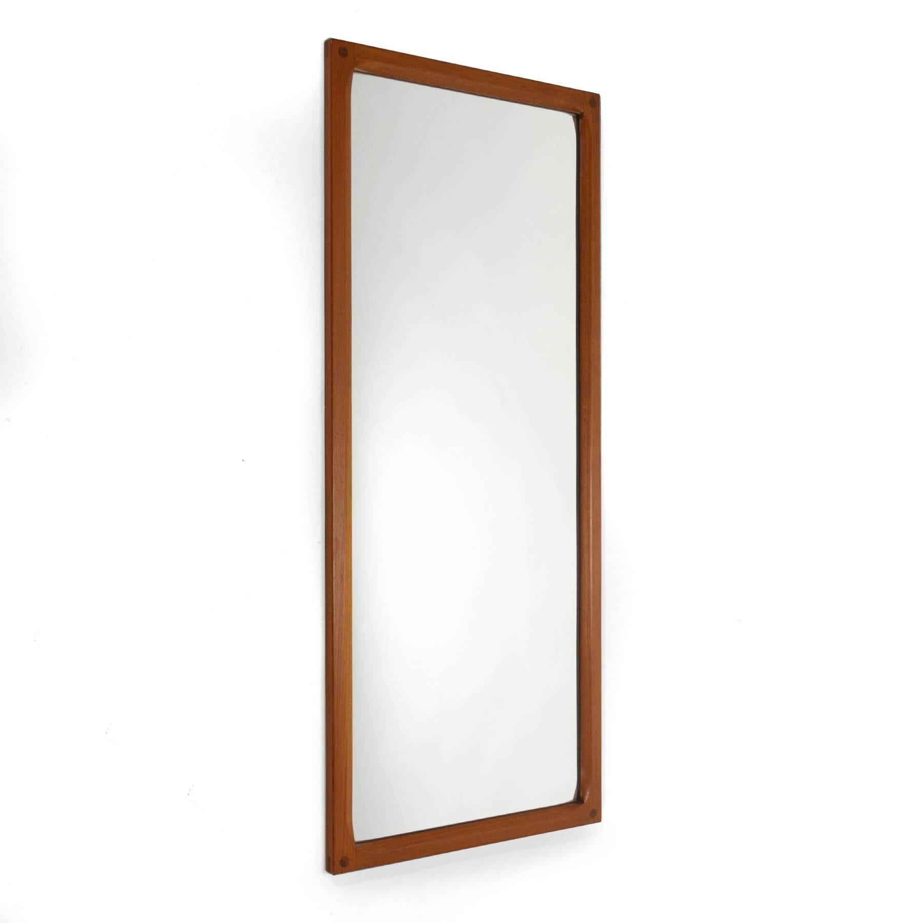This Aksel Kjersgaard wall mirror by Odder has a beautifully crafted solid teak frame. The interior edges are deeply scalloped and the corners have wonderful exposed joinery.