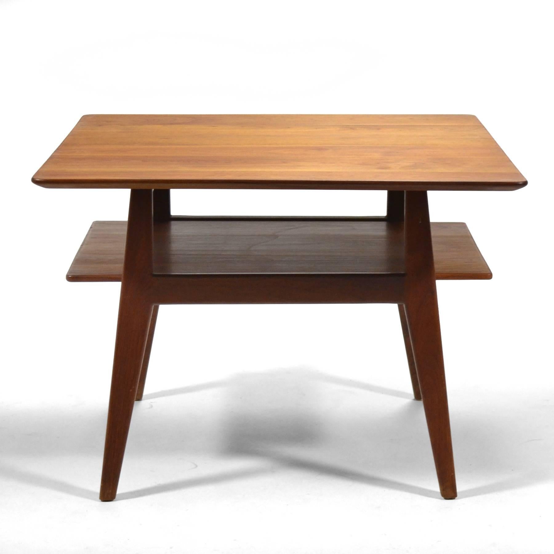A beautiful design by Jens Risom executed in solid walnut, this early model 433 table has wonderful lines, a lower shelf, and a top with a deeply beveled edge.

 