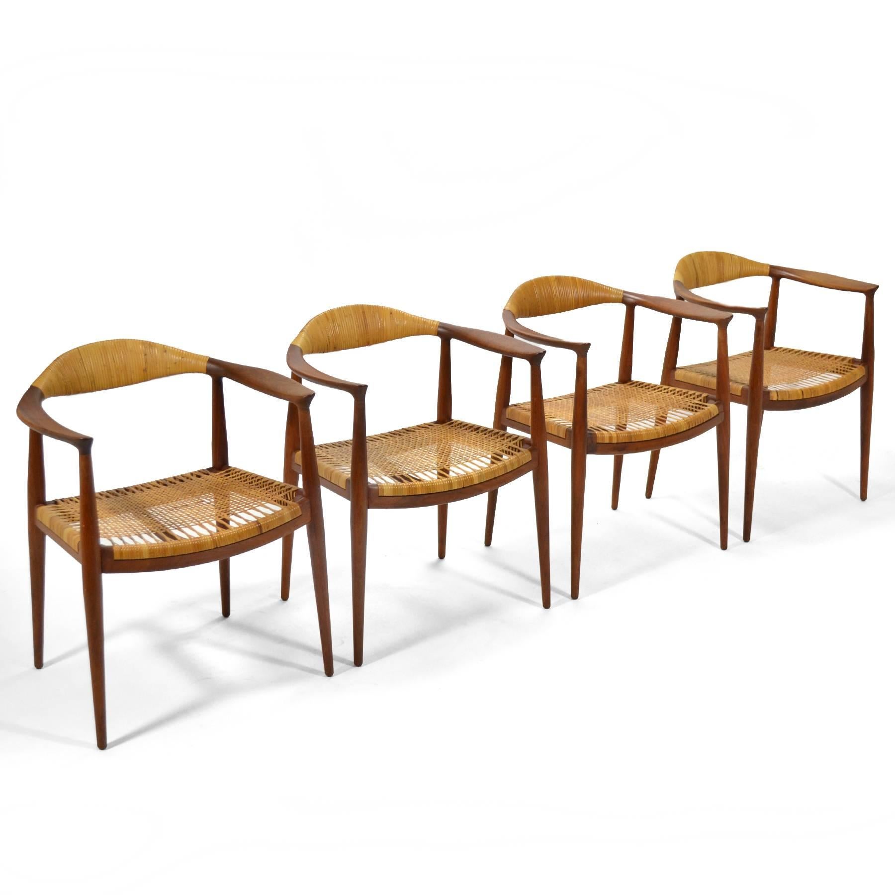 This set of four vintage chairs in the manner of Hans Wegner are very well executed. They have teak frames, cane seats and cane-wrapped backs.