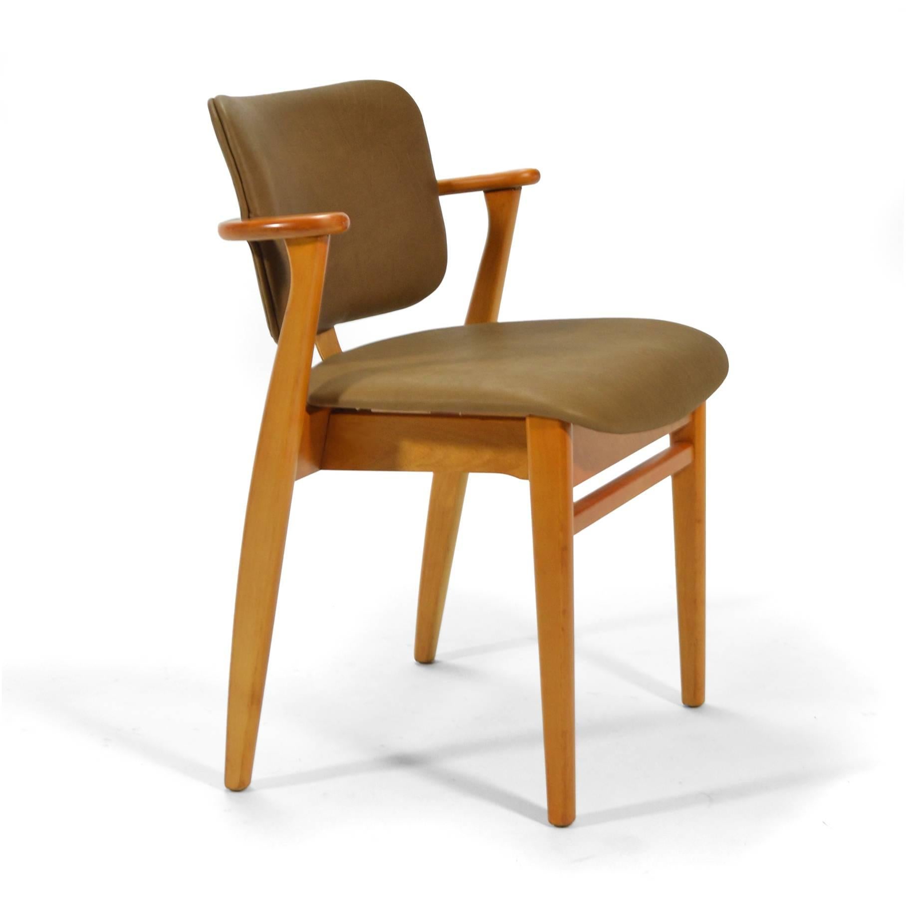 A wonderful 1946 design by Ilmari Tapiovaara, the Domus chair was offered entirely of wood, with an upholstered seat, or an upholstered seat and back. This nice example, has beautiful new leather upholstery . 

The scale of the design and the