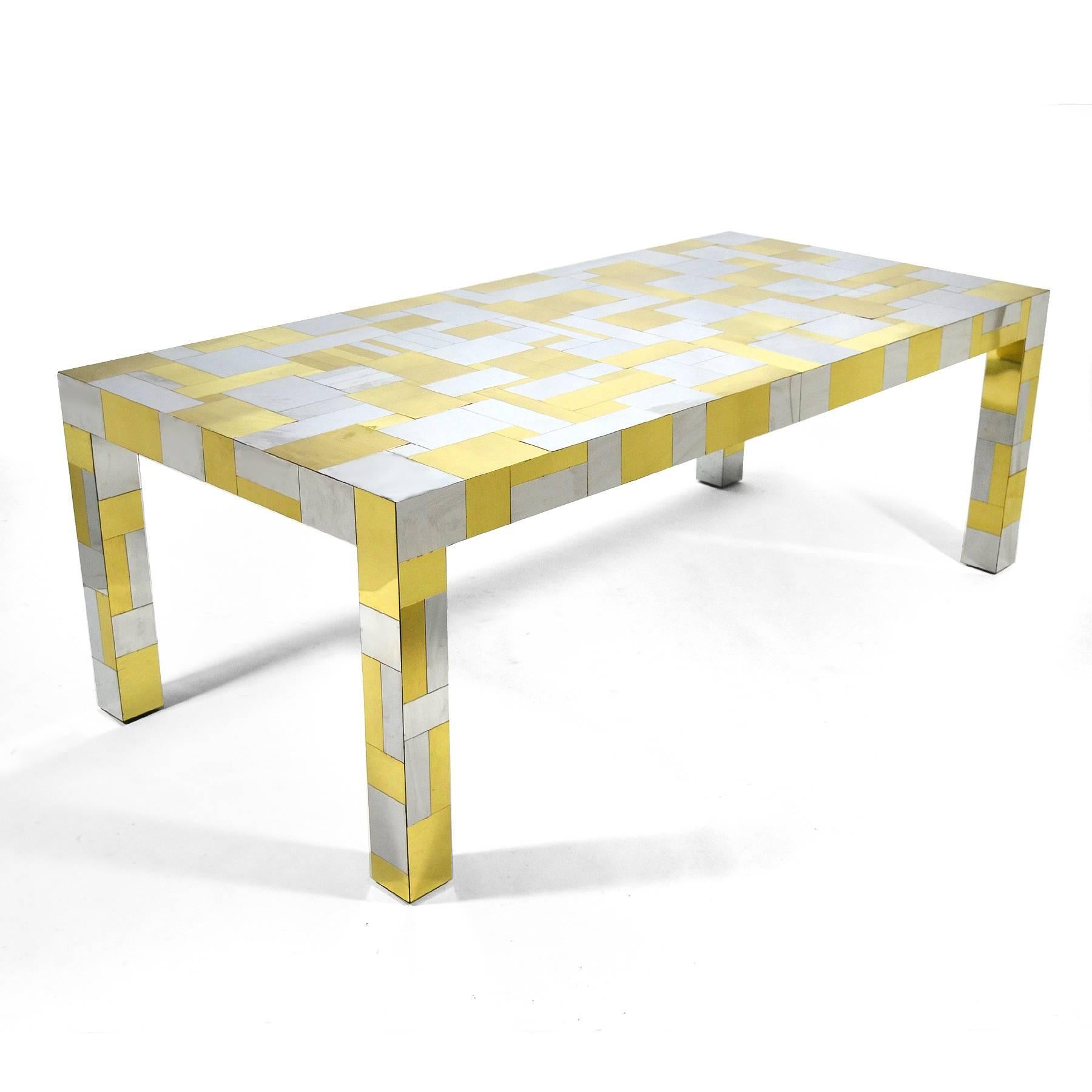 This large and dramatic dining table by Paul Evans is from his PE 200 Cityscape series and is covered in a patchwork of brass and chrome. The Parsons table form is 80