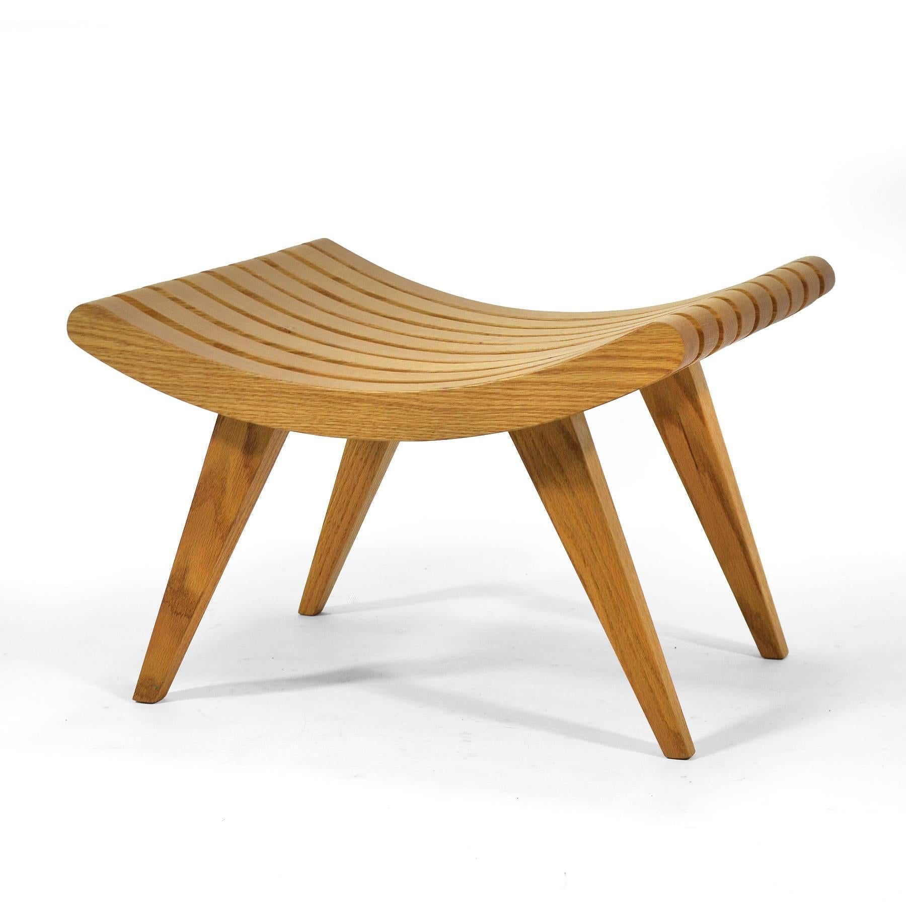 This handsome 1945 design by Edward Durell Stone was made by Fulbright furniture. A great occasional piece, the oak bench is both a sculptural presence and a comfortable seat.
