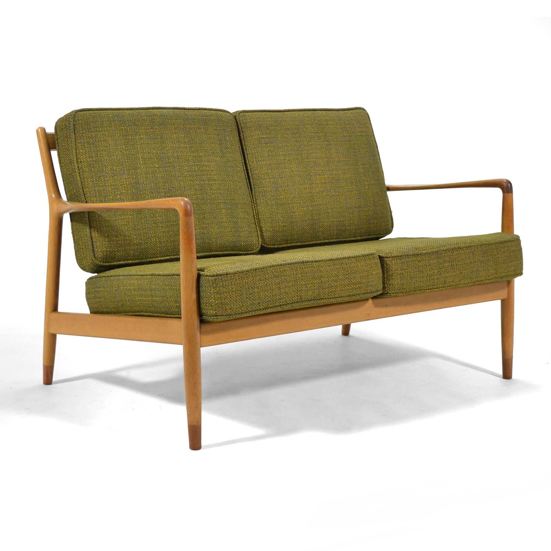 This beautiful early Folke Ohlsson two-seat sofa by DUX was crafted of solid oak with teak feet and an exquisite woven wool fabric. The original upholstery has been cleaned and restored with brand new foam.

 

 