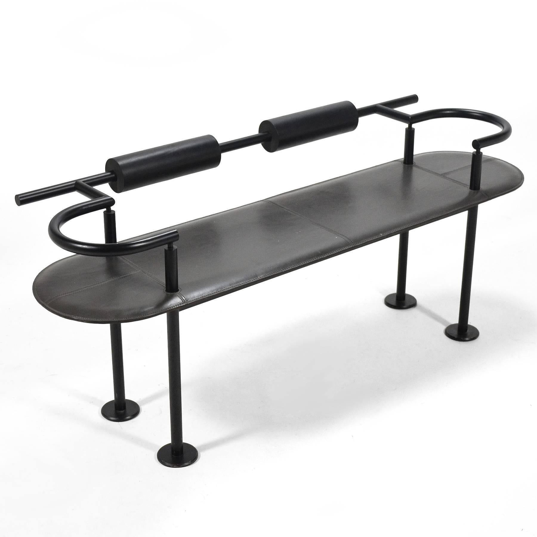 This delightful Italian Postmodern bench has a frame of tubular steel, a leather-wrapped seat, and dense foam backrests. It's innovative use of modern materials, exaggerated expression of the form and its components harkens to Sottsass's designs for