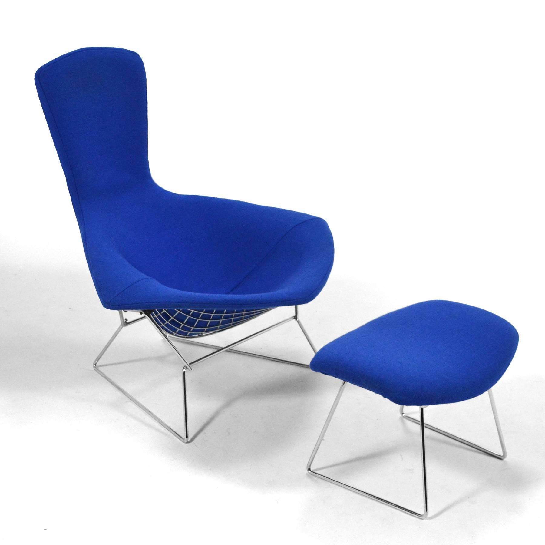 This early bird chair and ottoman by Harry Bertoia for Knoll has a frame of chromed steel and a vivid blue cover. The fame is the cleanest we've ever seen and the fabric is in great original condition. We have had the original cover cleaned and