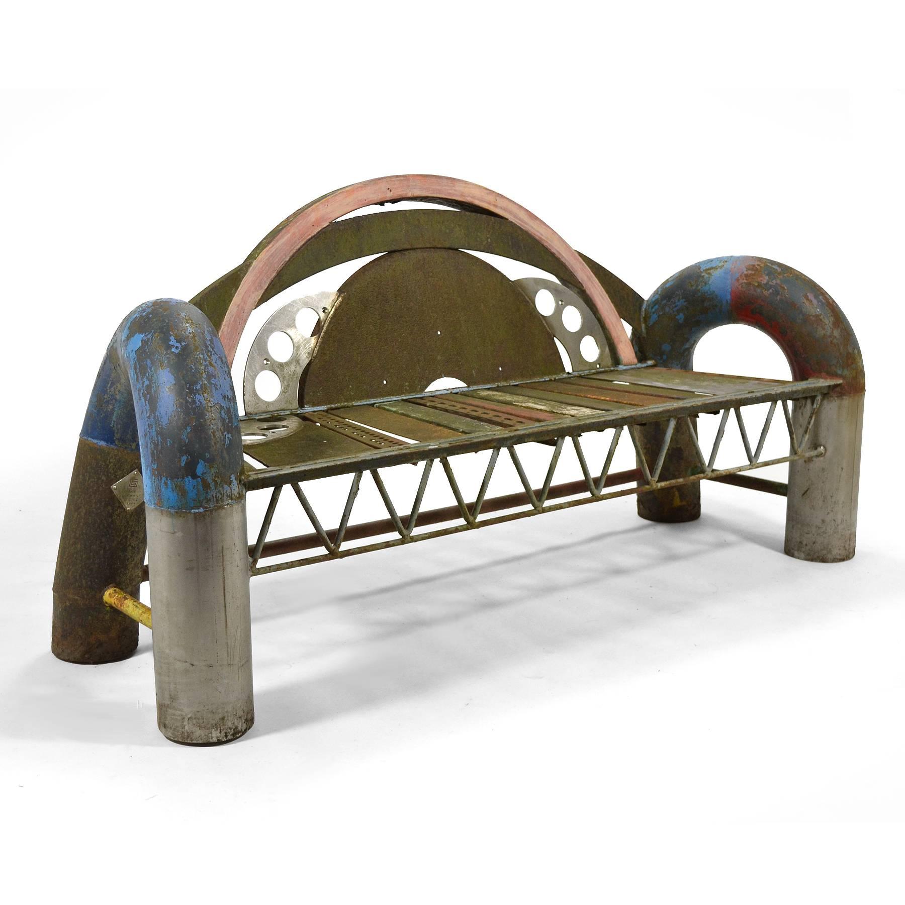 Georgia-based sculptor Gordon Chandler created a series of large benches in the 1990s using reclaimed metal. They were intended to be used either indoors or out. This beautiful example is made of painted steel and stainless steel, incorporating