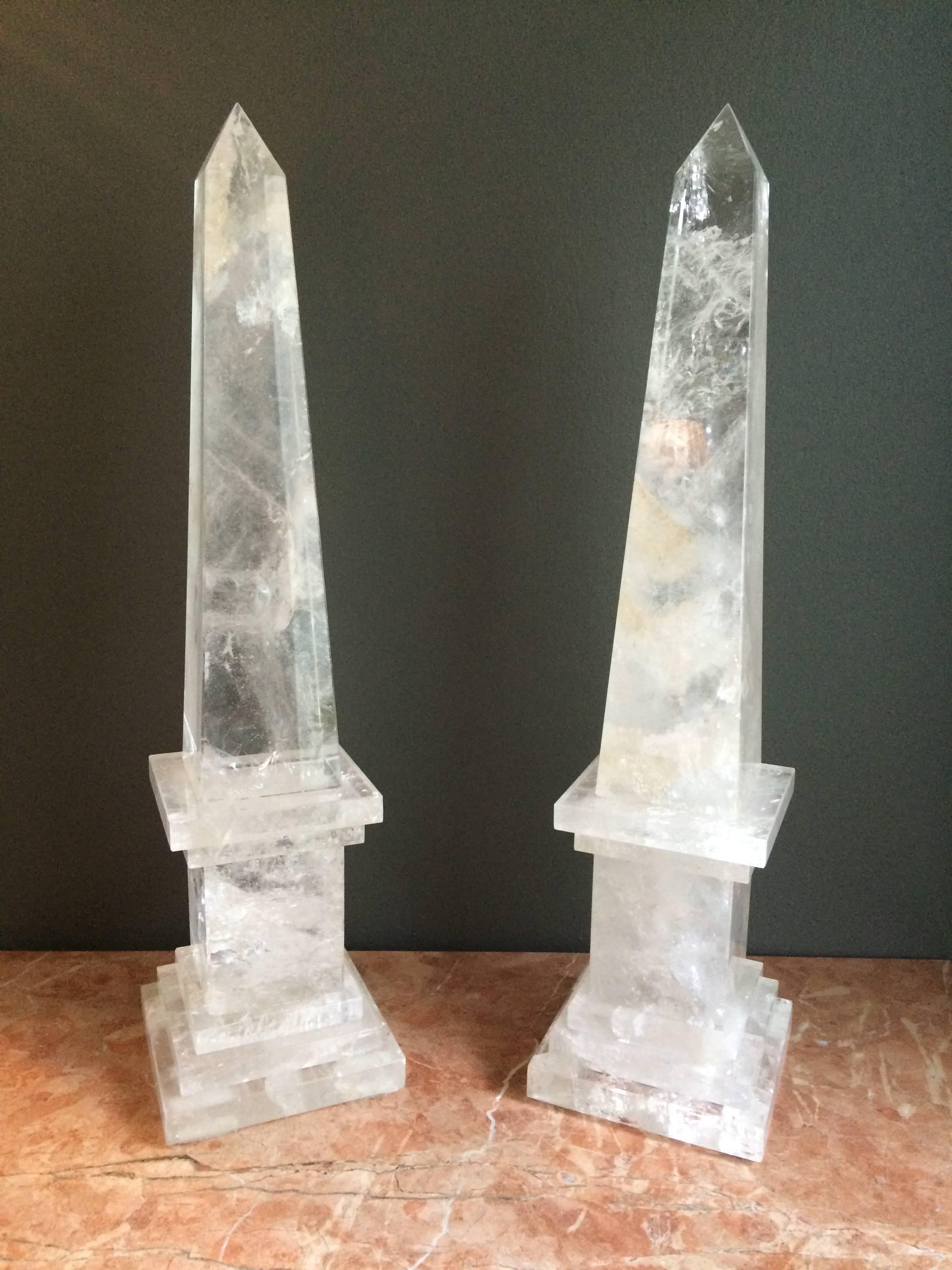 A pair of rock crystal obelisks on square cut step bases.