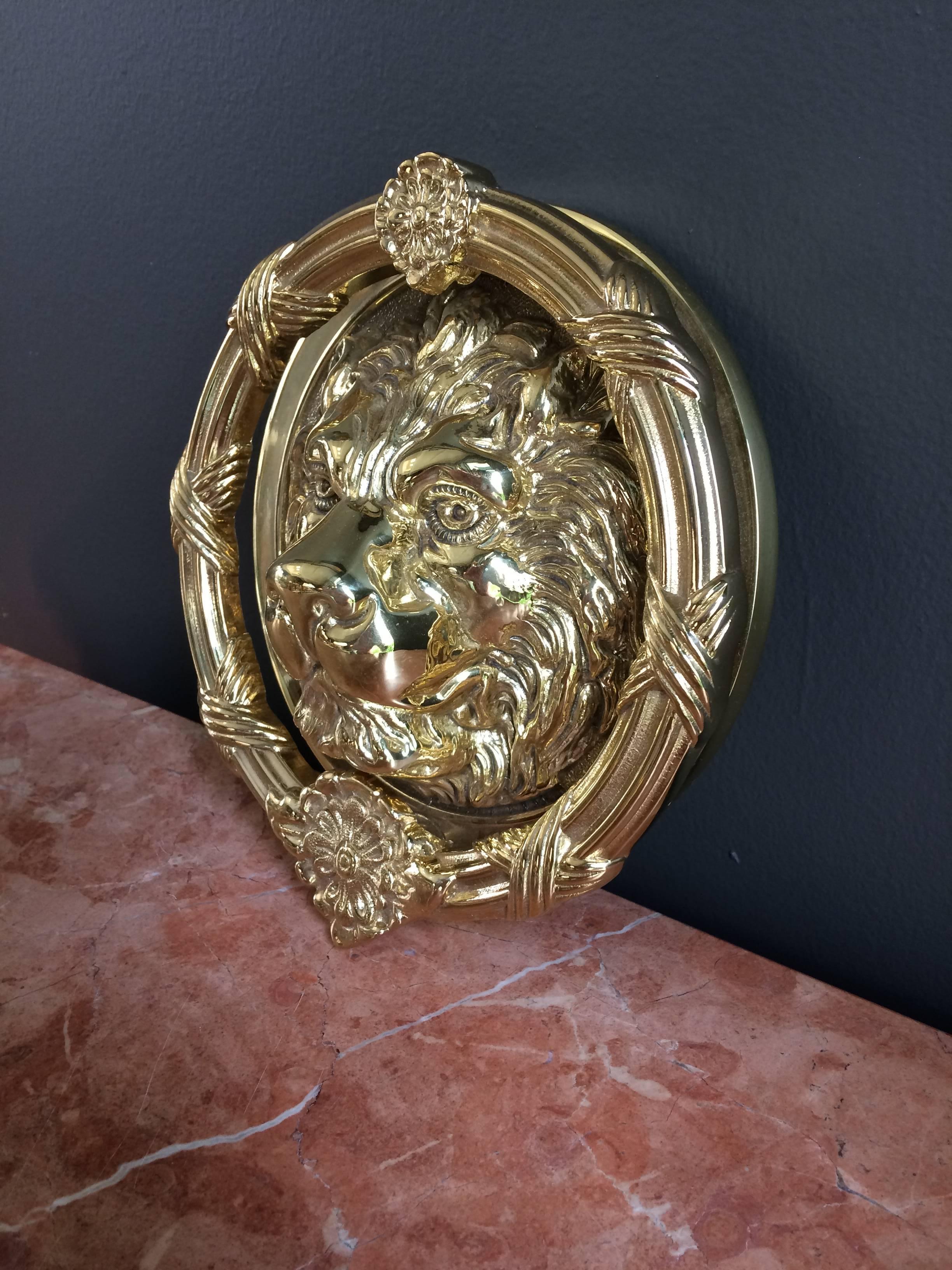 A handsome solid bronze doré round frame lion's head door knocker.