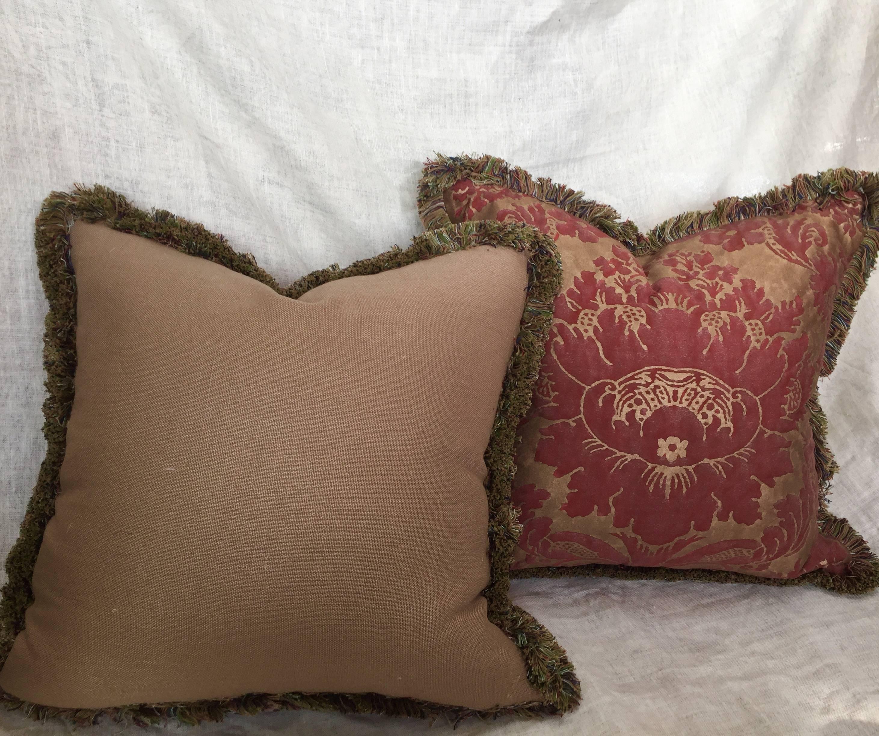 Decorative pair of red and gold Fortuny cushions with multicolored brush fringe.