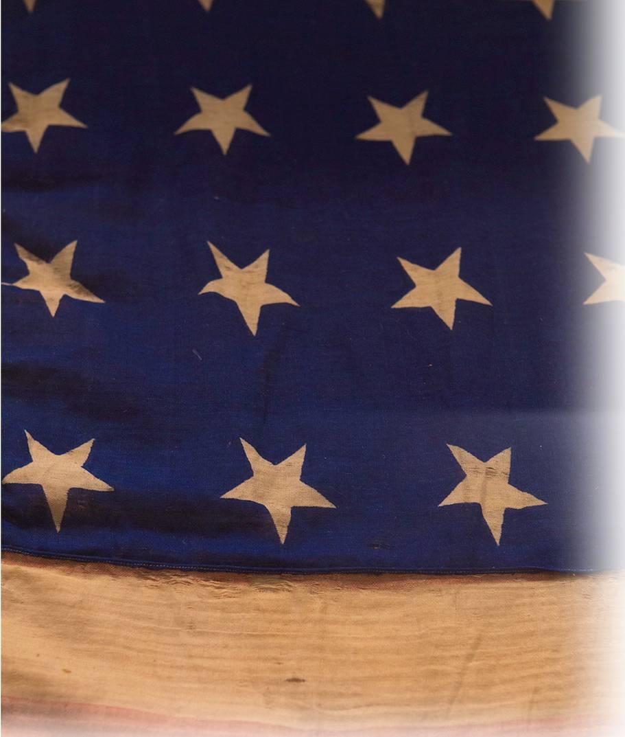 This is an exceptional 32-star, printed American flag celebrating Minnesota's admission to the United States.  This is an extremely rare star count -- primarily due to the fact that the 32-star flag was the official flag of America for just one year