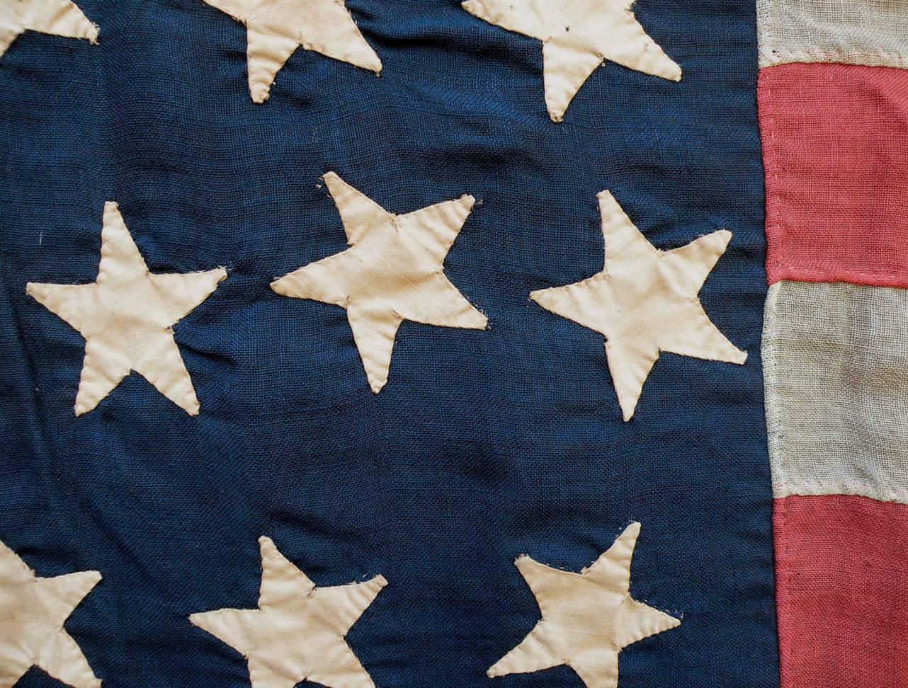 This is a striking hand-cut and hand-sewn 38-star American flag. The 38th star was added to the flag to commemorate Colorado statehood. Since it was admitted to the Union in 1886, Colorado earned the nickname the 