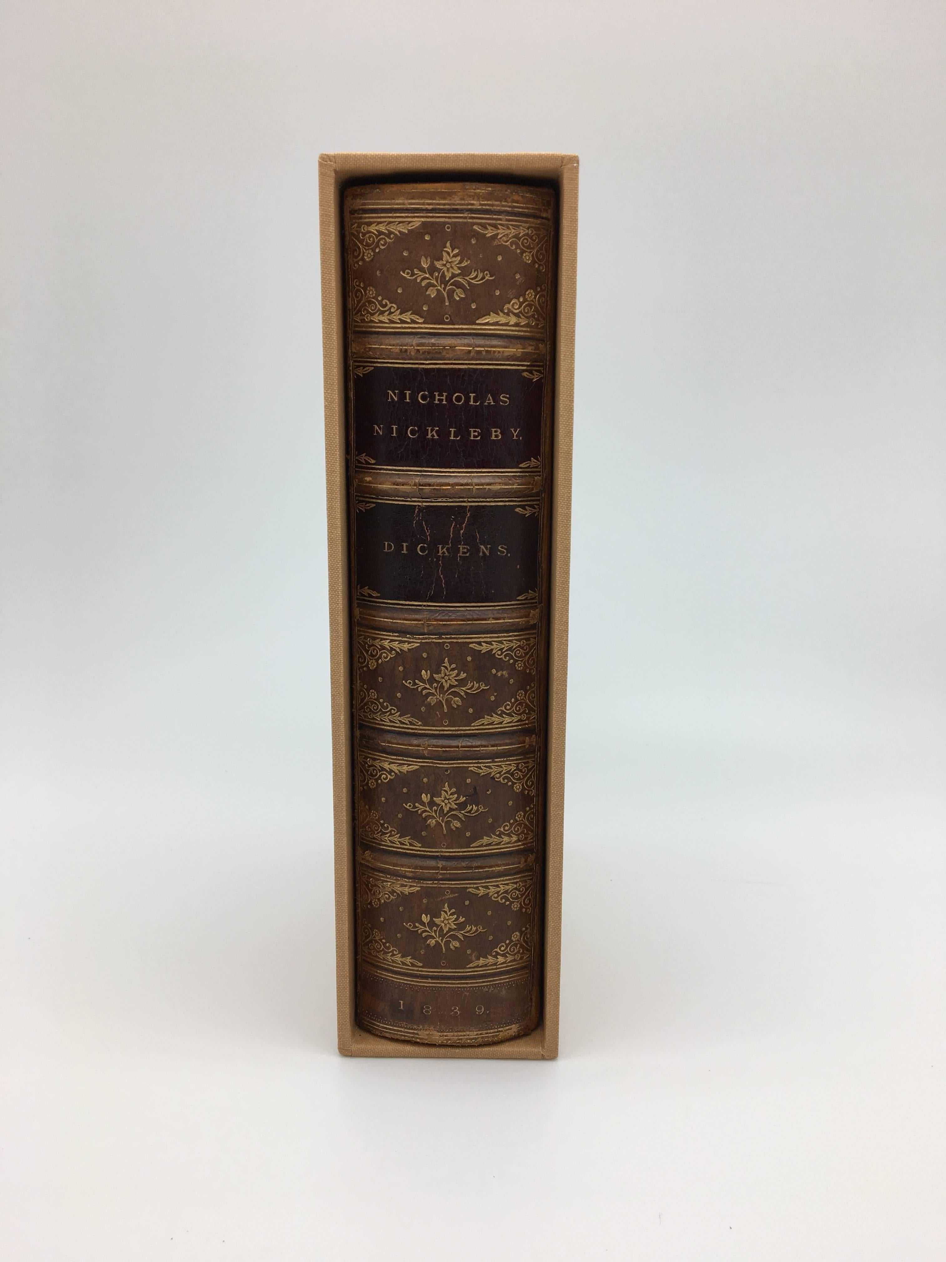 Dickens, Charles. The Life and Adventures of Nicholas Nickleby. London: Chapman and Hall, 1839. Bound in period in leather and housed in a custom cloth slipcase with a portrait of the author on the cover. First edition of Dickens’ third novel and