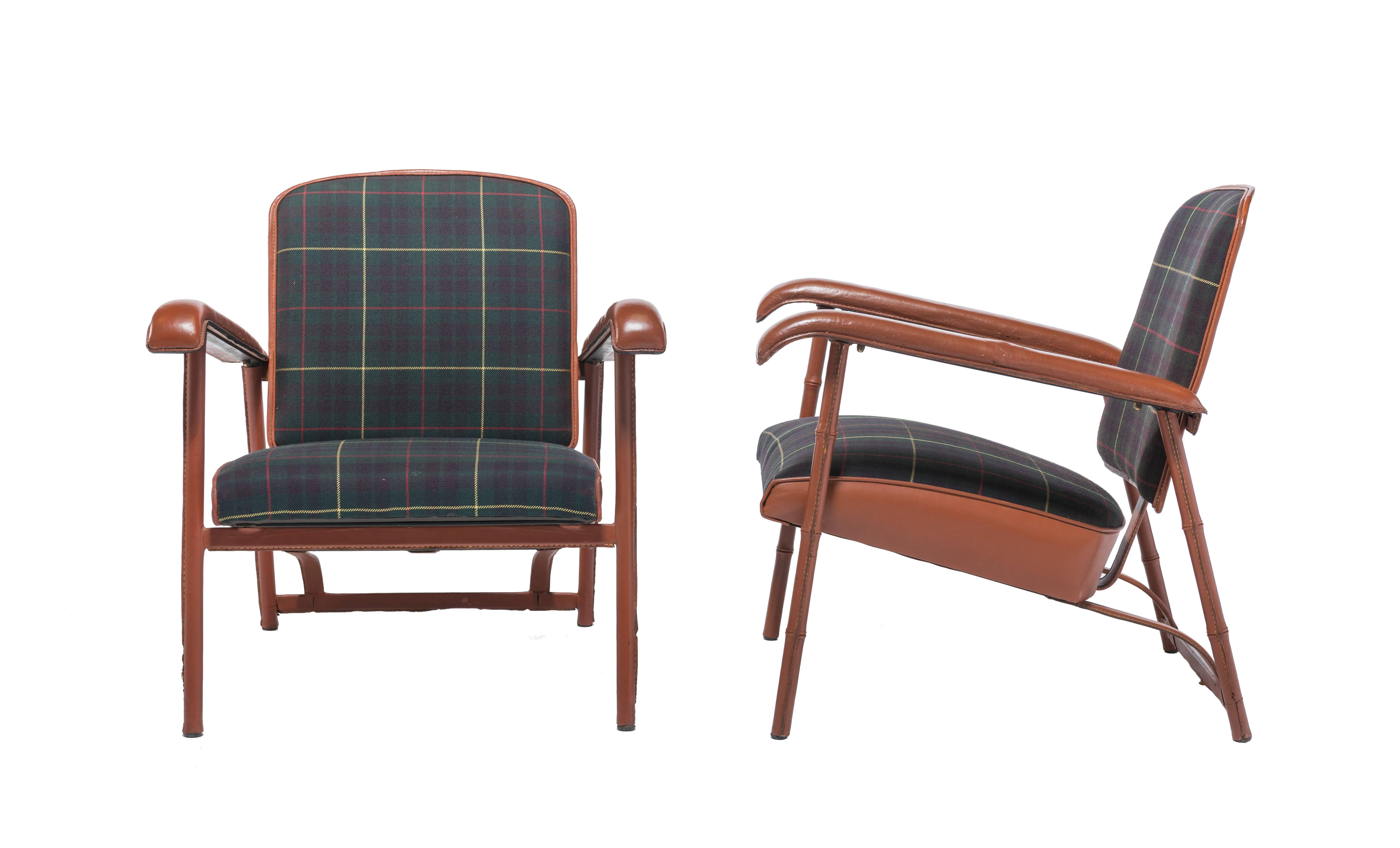 Rare and handsome pair of Adnet lounge chairs with original Tartan plaid wool upholstery. This pair of “Mr. and Mrs.