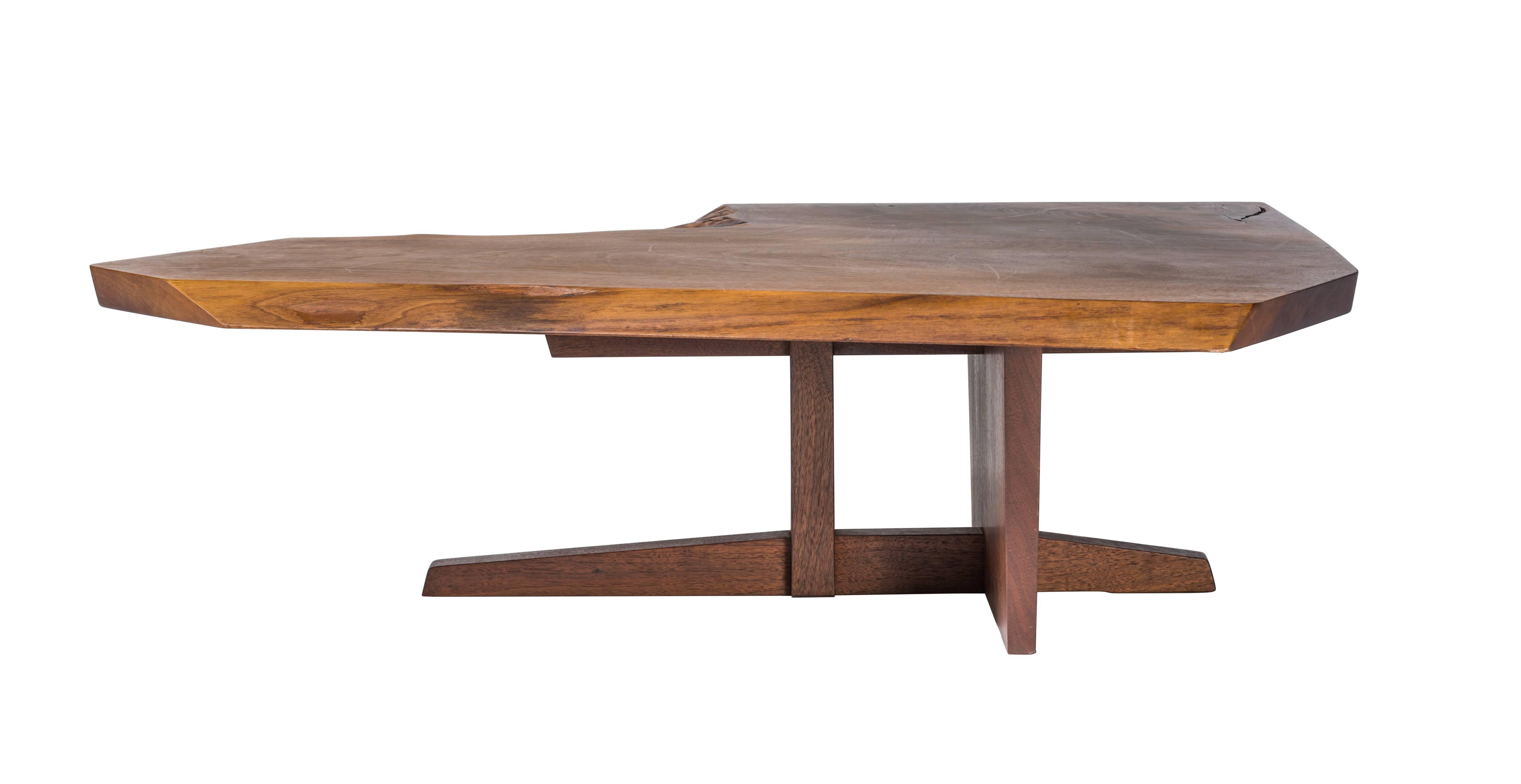 Excellent Nakashima walnut coffee table atop a rare Ming II base. Nice expressive top with sap edge and a crotch cut edge. Signed and dated 