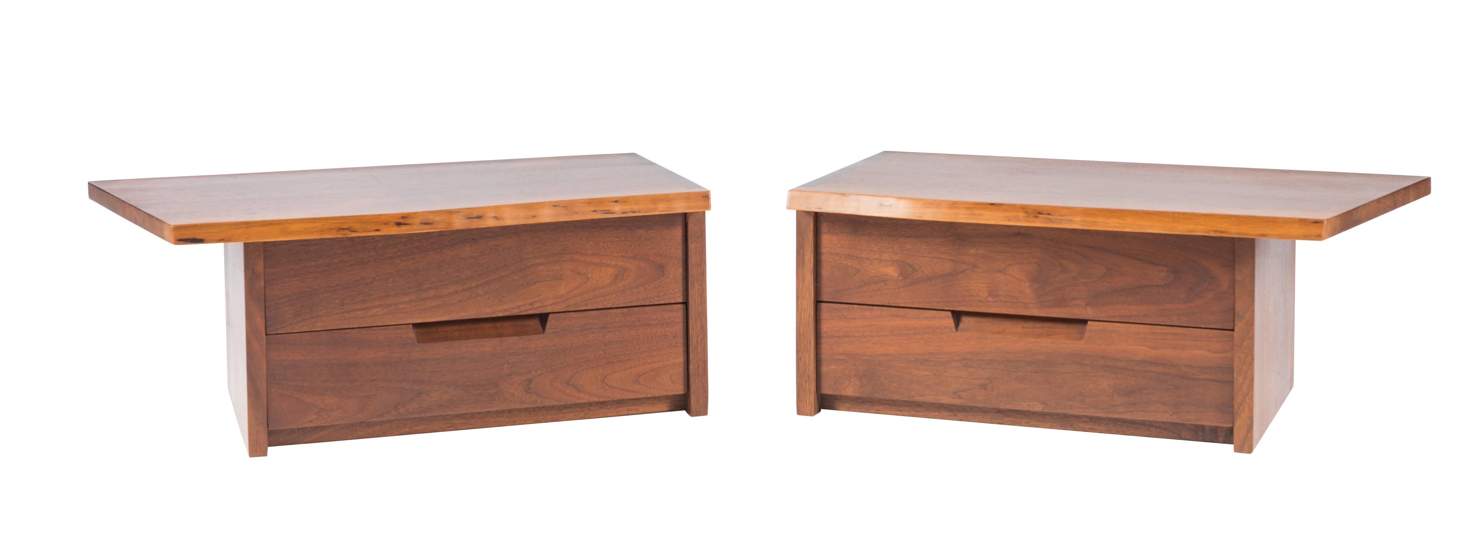 Exceptional and very rare pair of black walnut wall mounted nightstands or bedside tables. Cases with free-edge fronts, over-hang left and right and dovetailed at square ends. Each case with two drawers. Comes with letter of Provenance, circa 1963.