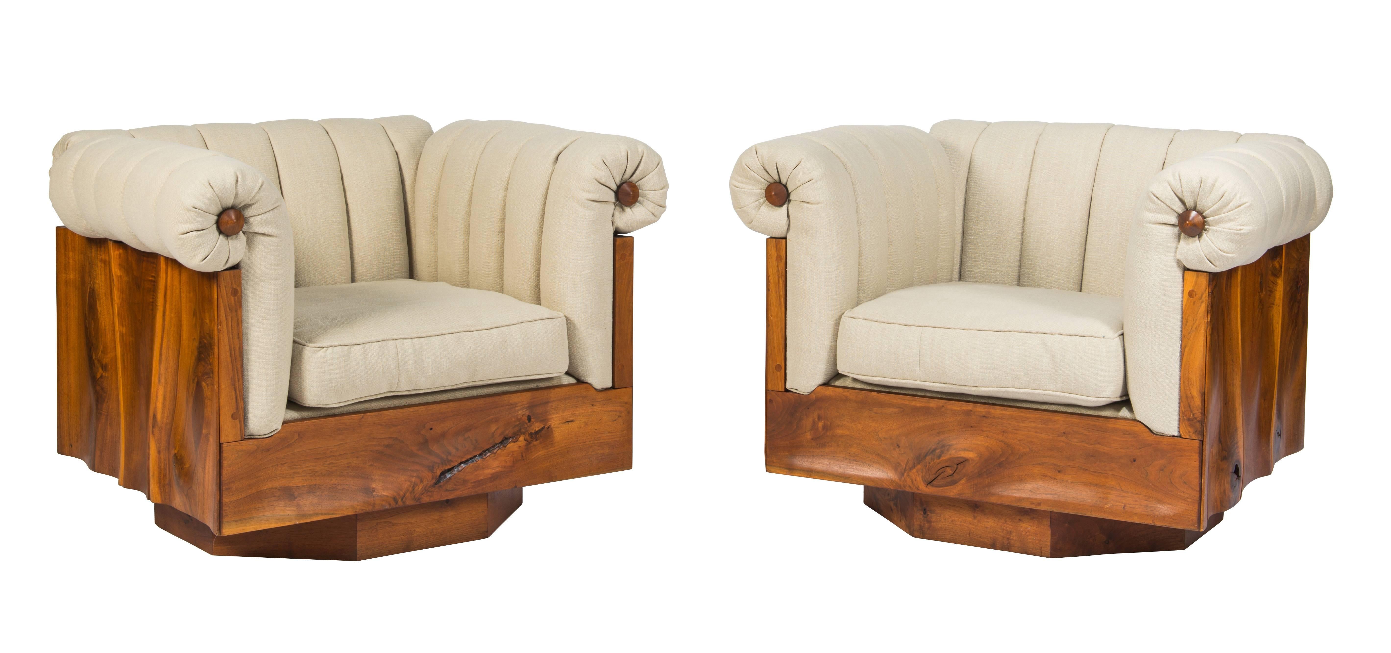 Pair of large impressive and unique Powell lounge chairs in hand-sculpted walnut on octagonal swivel bases. These chairs were made for a life-long friend of Powell's and are the only examples he produced. There is a 3rd chair also available. Chairs